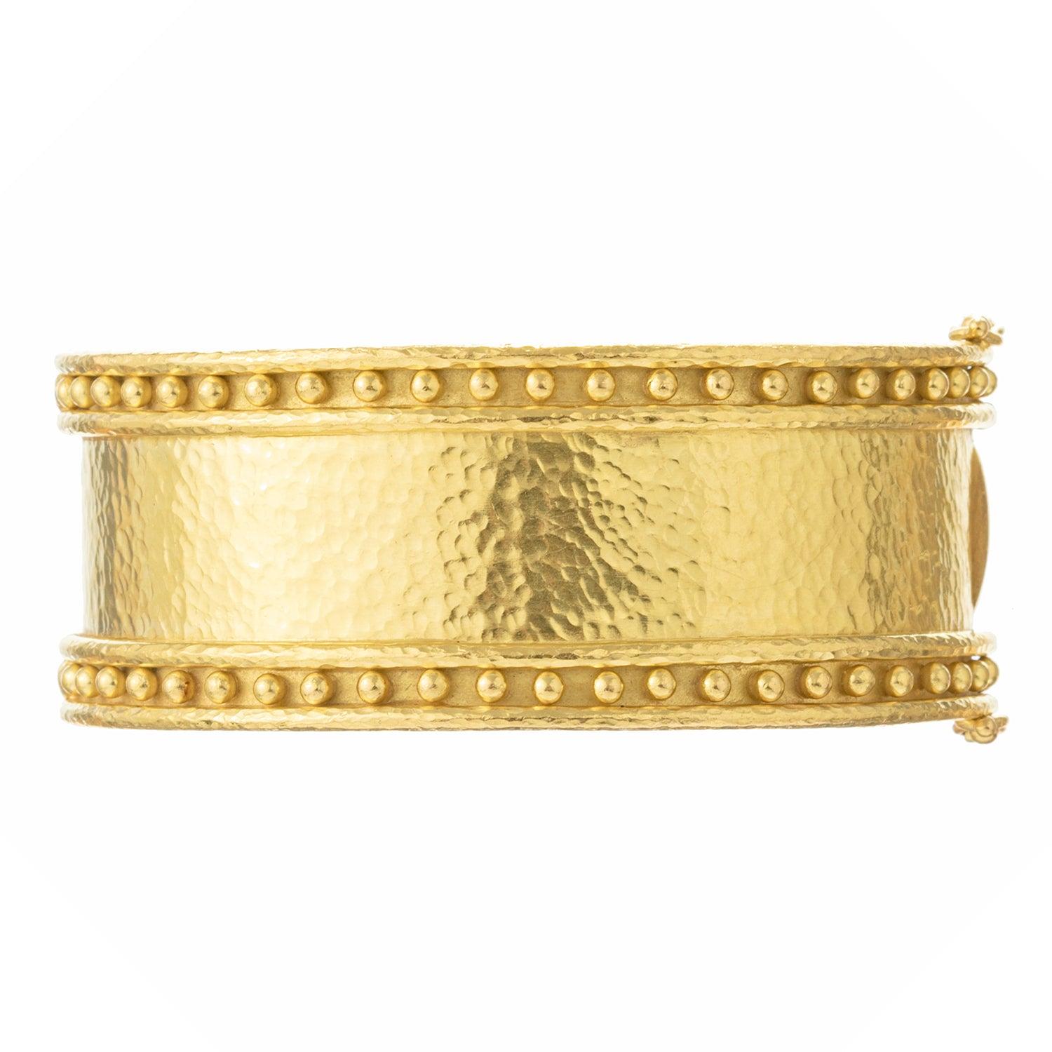Wide bangle bracelet, in hammered 19k yellow gold framed by a row of Elizabeth Locke's signature granulated gold beading around the circumference on either side. Hinged with safety clasp. Stamped 