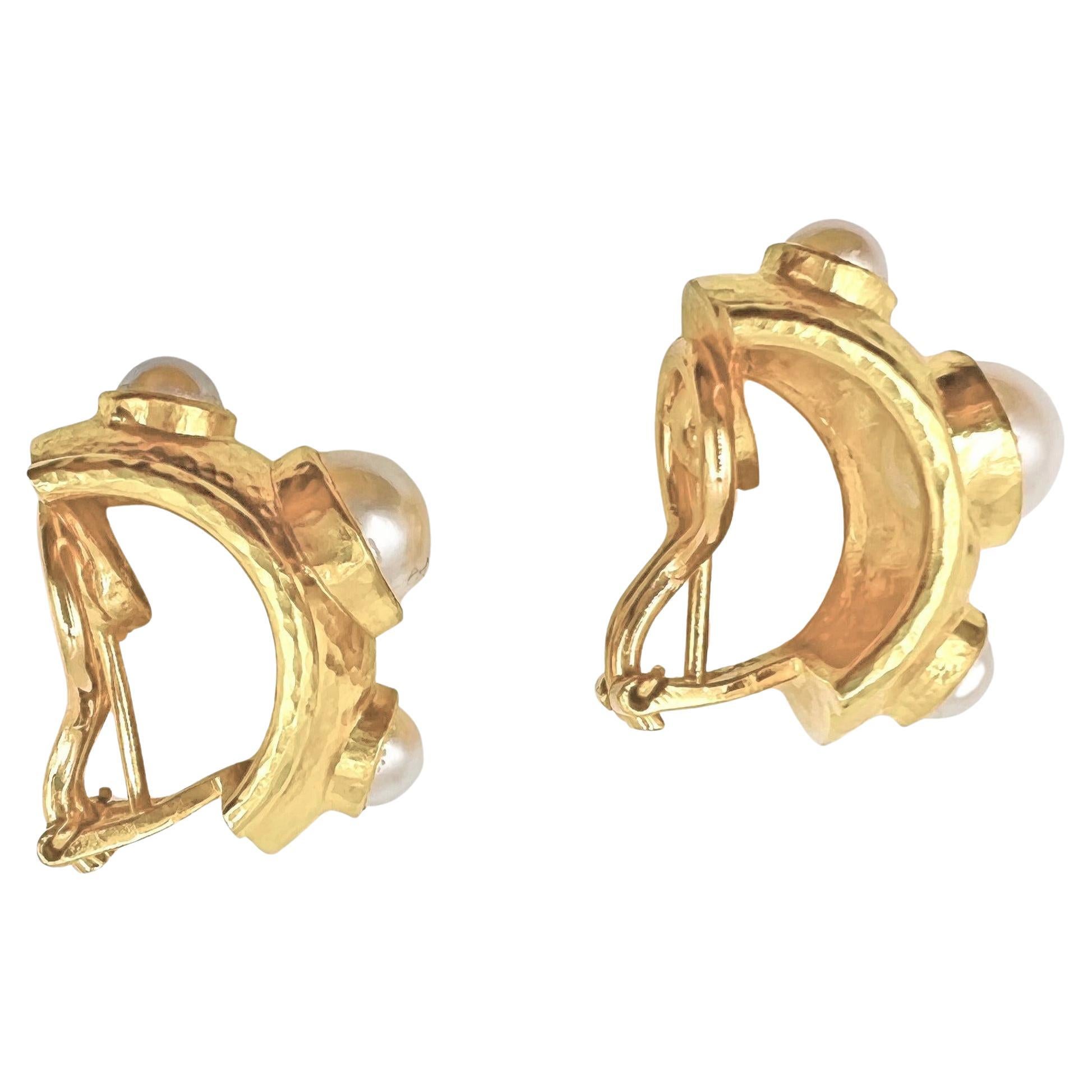 Elizabeth Locke pearl half hoop earrings in 19k yellow gold.  Bezel-set with three half-cultured pearls measuring 5-8mm.  Hammered half hoop design with omega clip backs and optional hinged, fold-down posts for pierced wearers.  Signed 'EL' for