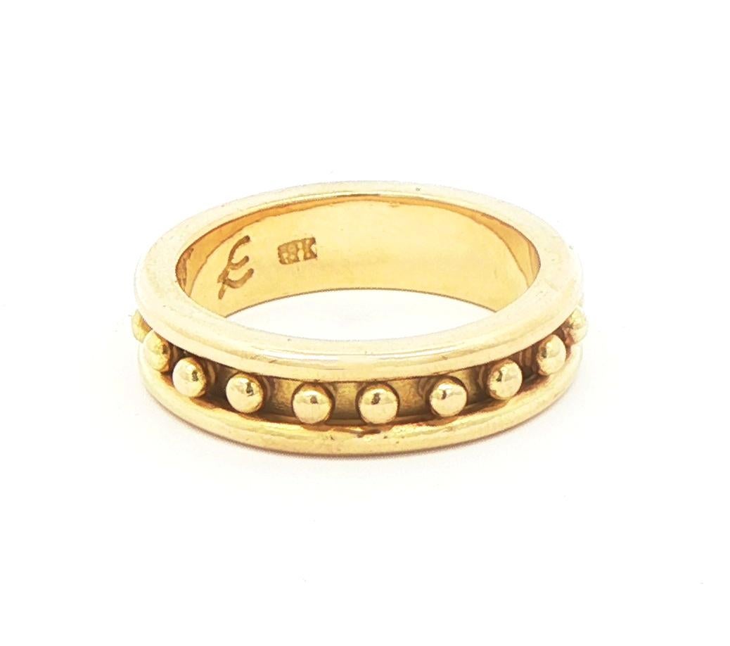Crafted from 19kt yellow gold, the Elizabeth Locke Narrow Granulated Stack Ring showcases a 5mm band with bead motifs along the center strip. The perfect addition to any jewelry collection, this ring boasts a refined and elegant appearance. Finger