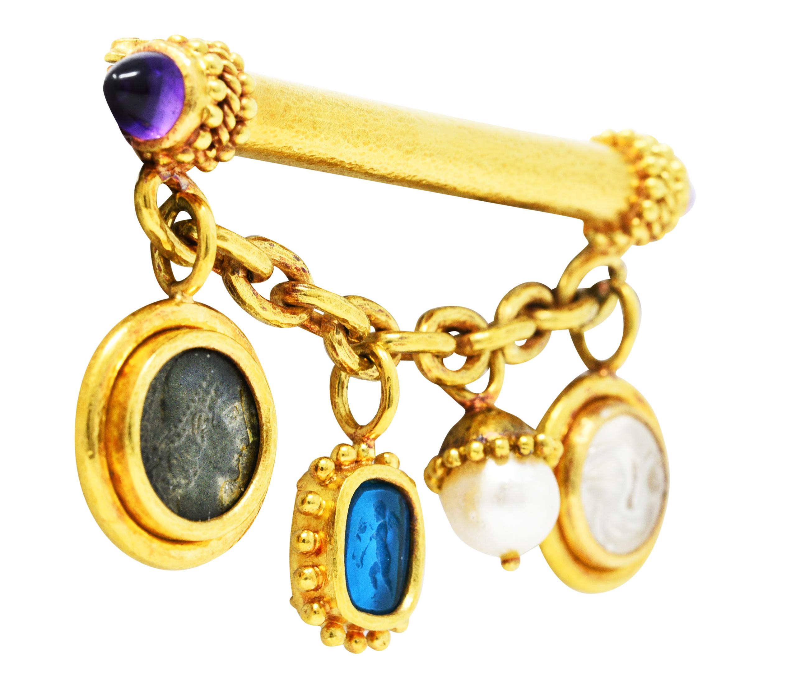 Brooch is designed as gold bar with ornate gold beaded terminals featuring amethyst bullet cabochons

Amethyst is transparent reddish-purple to purple with moderate color zoning and medium saturation

With swagged cable chain suspending pearl,