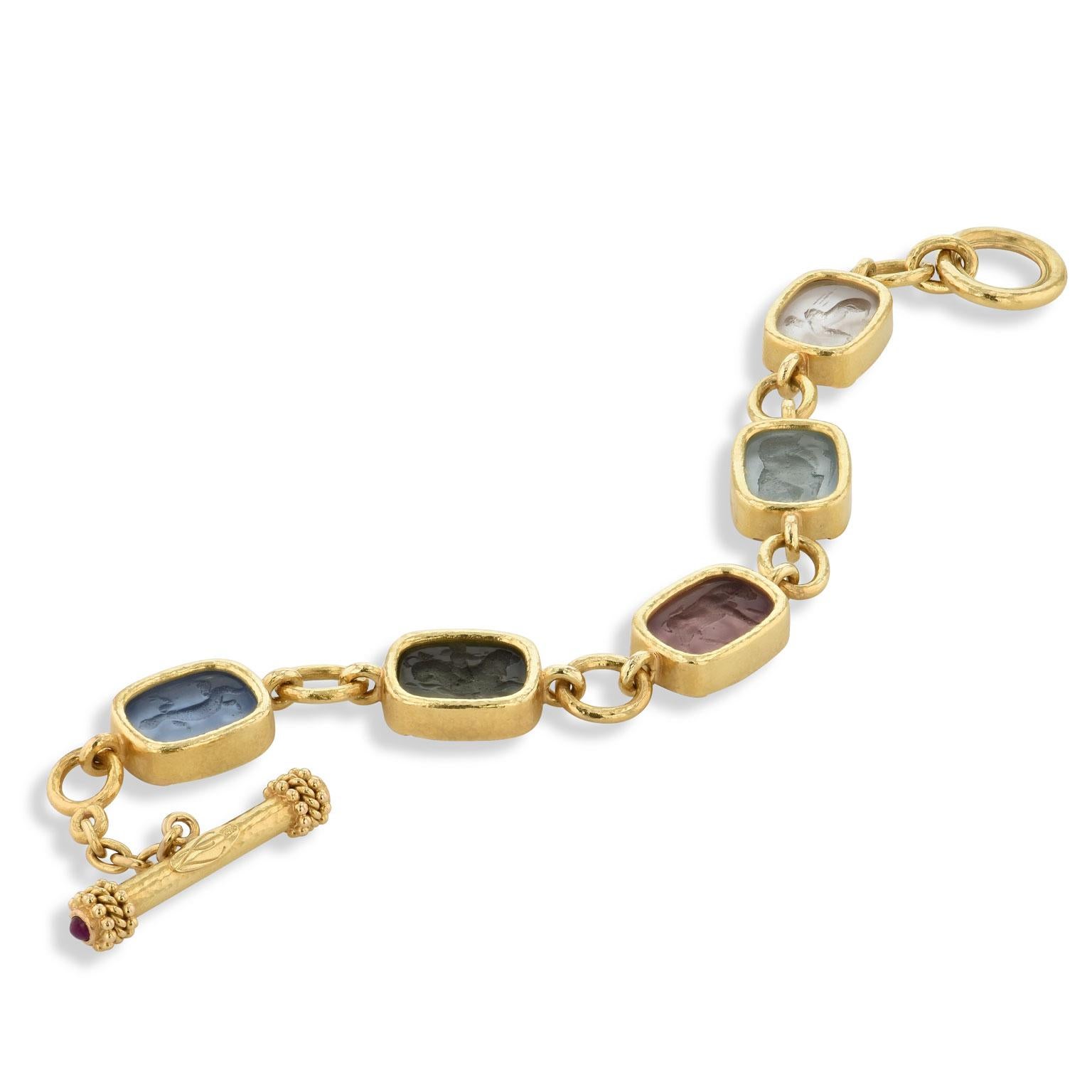 This previously loved Elizabeth Locke 18 karat yellow gold toggle bracelet features five multi-color intaglio incised antique animals. Make a bold statement with this spirited piece (Estimated Retail $8,050).