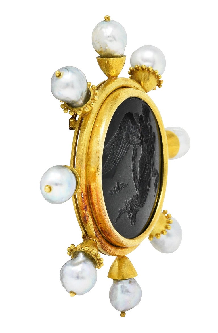 Brooch centers a Venetian glass intaglio - opaque black in color with gloss finish. Depicting the Greek goddess Nyx carrying her two children Hypnos and Thanatos. With flowing gown, texturous feather wings, and her iconic owl. Bezel set in a