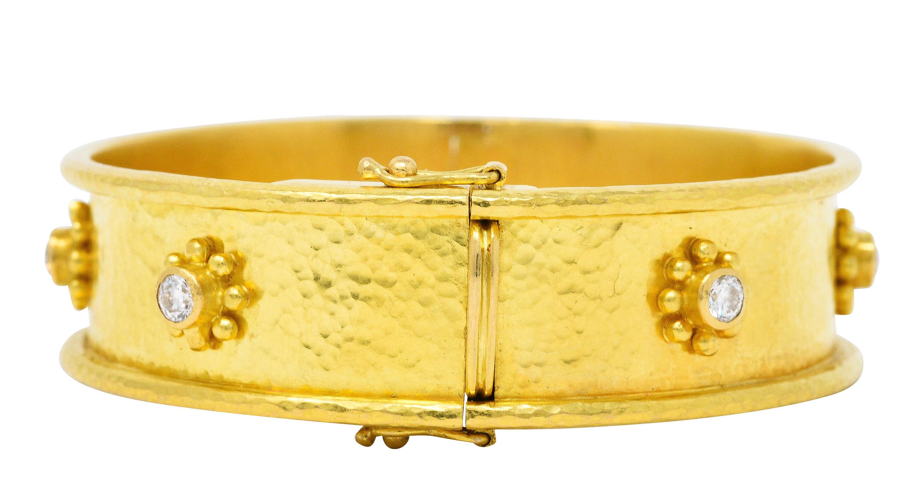 Hinged bangle bracelet has a finely hammered finish throughout

With bezel set diamond stations throughout accented by gold bead surrounds

Round brilliant cut diamonds weigh in total approximately 0.85 carat - G/H color with VS clarity

Completed