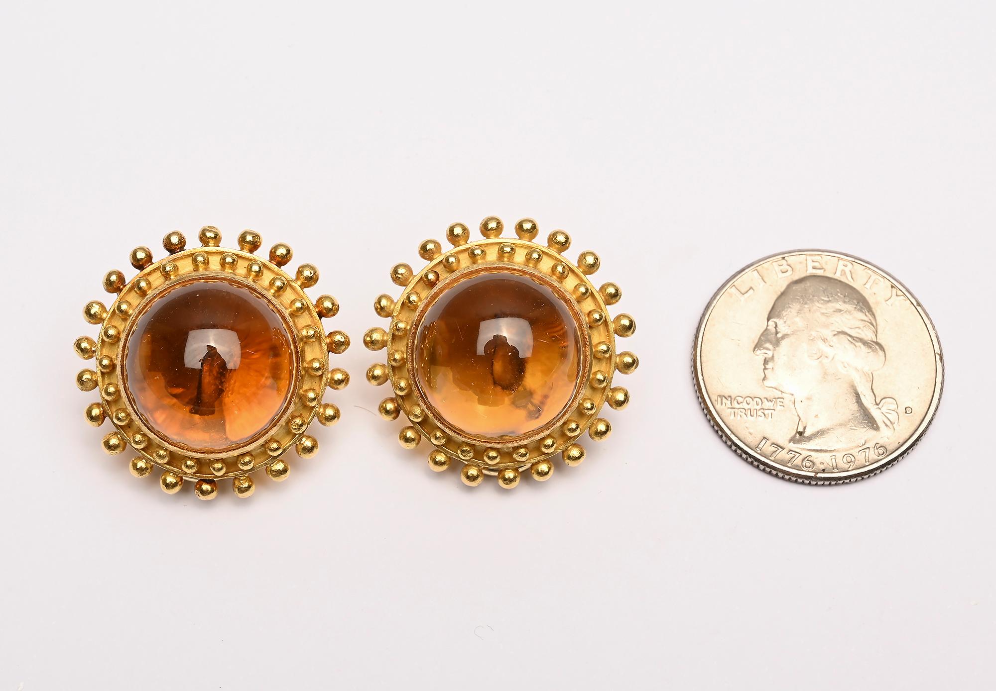 Elizabeth Locke large round earrings with a beautiful honey colored citrine. The stone is surrounded by two rows of gold beading. The earrings are 1 inch in diameter as seen photographed next to a quarter.
Backs are clips and collapsible posts.