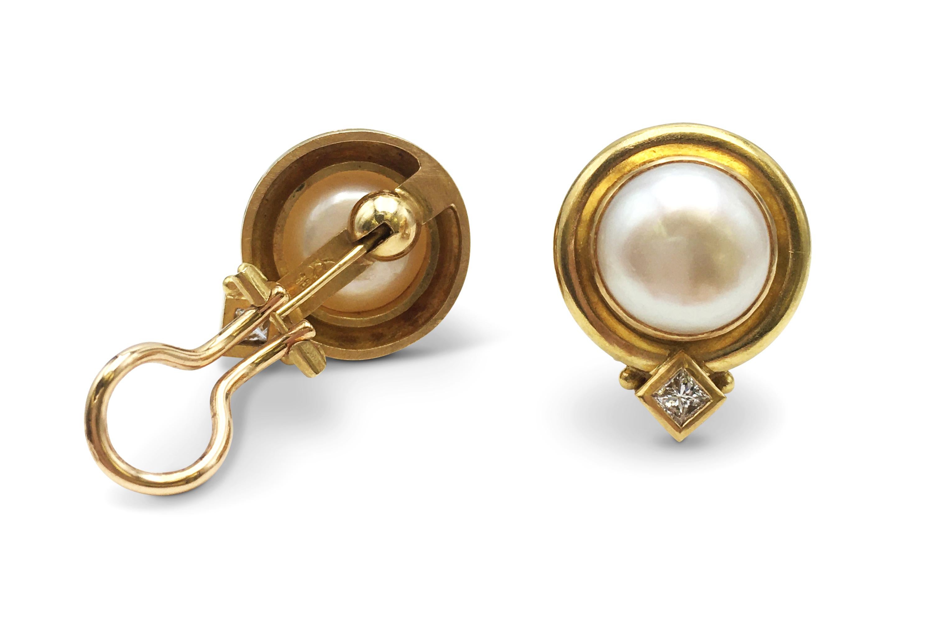 Authentic Elizabeth Locke earrings crafted in 18 karat yellow gold.  Each earring features a beautiful 12mm Mabe pearl and a square-cut diamond weighing approximately .10ct.  The Earrings measure 22mm in length and 17mm at the widest point.  The