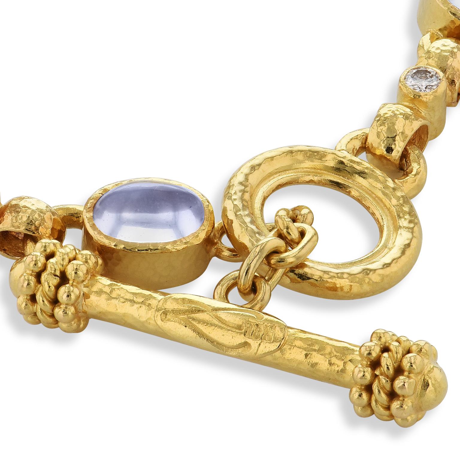 Hammered yellow gold radiates with brazen beauty as six cabochon moonstones illuminate between glimmering bezel-set diamond with a total weight of 0.55 carat in this previously loved 18 karat yellow gold toggle bracelet.