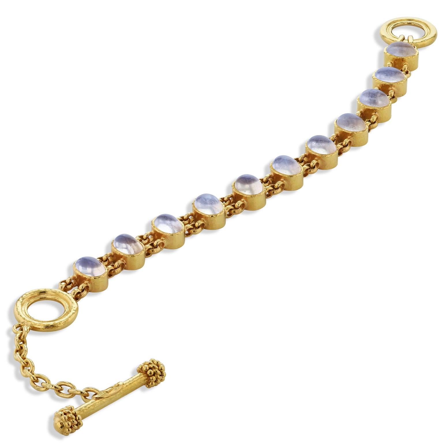Hammered yellow gold radiates with brazen beauty as 11 cabochon moonstones illuminate in this previously loved chain linked 19 karat yellow gold toggle bracelet.