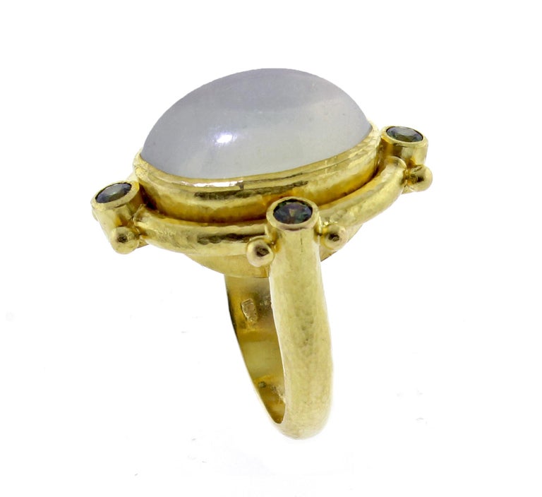 From Elizabeth Locke, a dramatic  19 karat moonstone ring. The cabochon moonstone measures 21*15.5mm and is highlight with faceted green tourmaline. Size 6½