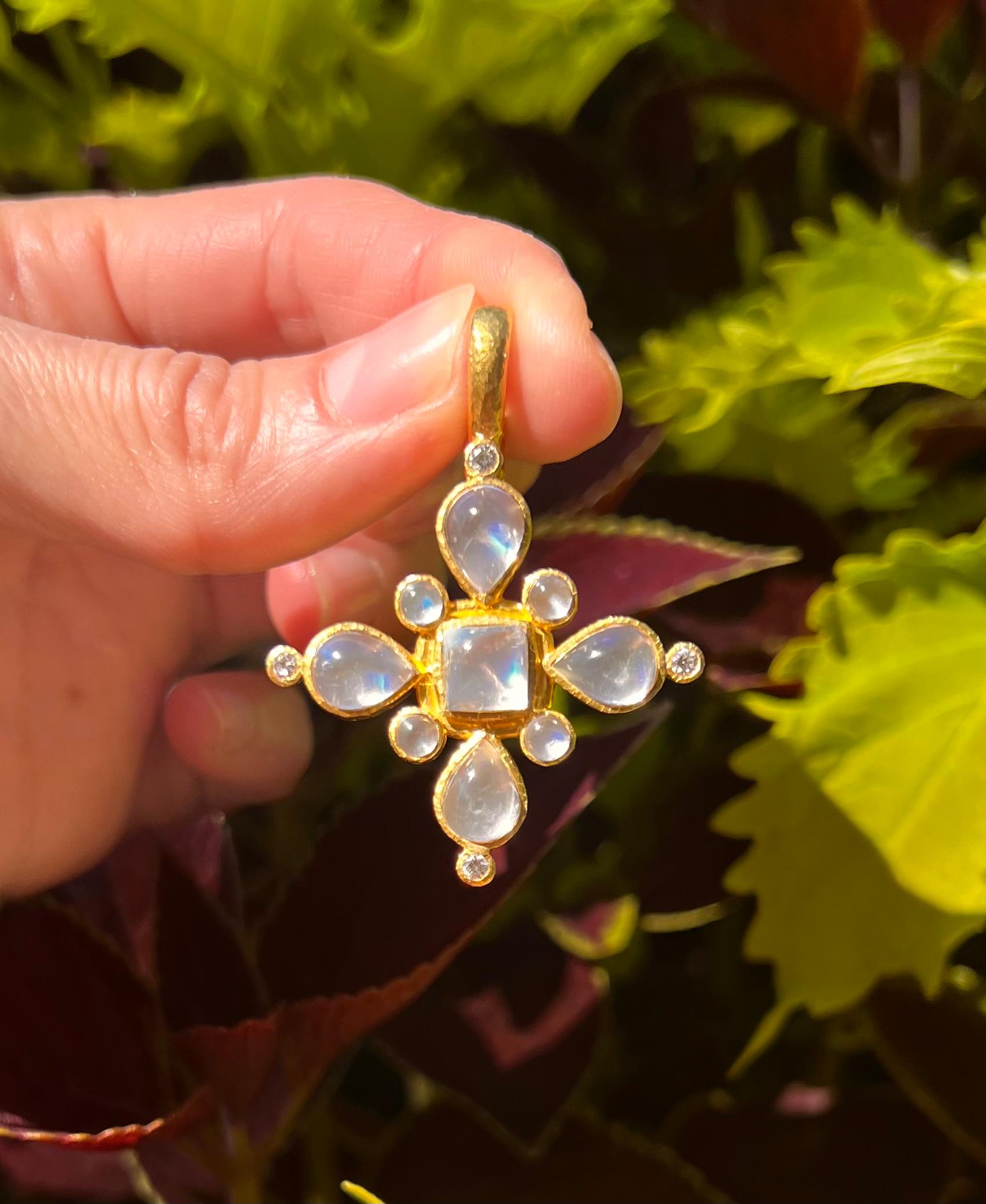 A stunning symbol of elegance, this Elizabeth Locke Maltese cross pendant is adorned with nine moonstones and four diamonds. The moonstones include four 9 x 7mm pear-shapes, one 7.2mm diameter cushion-shape, and four smaller round 4.25mm diameter