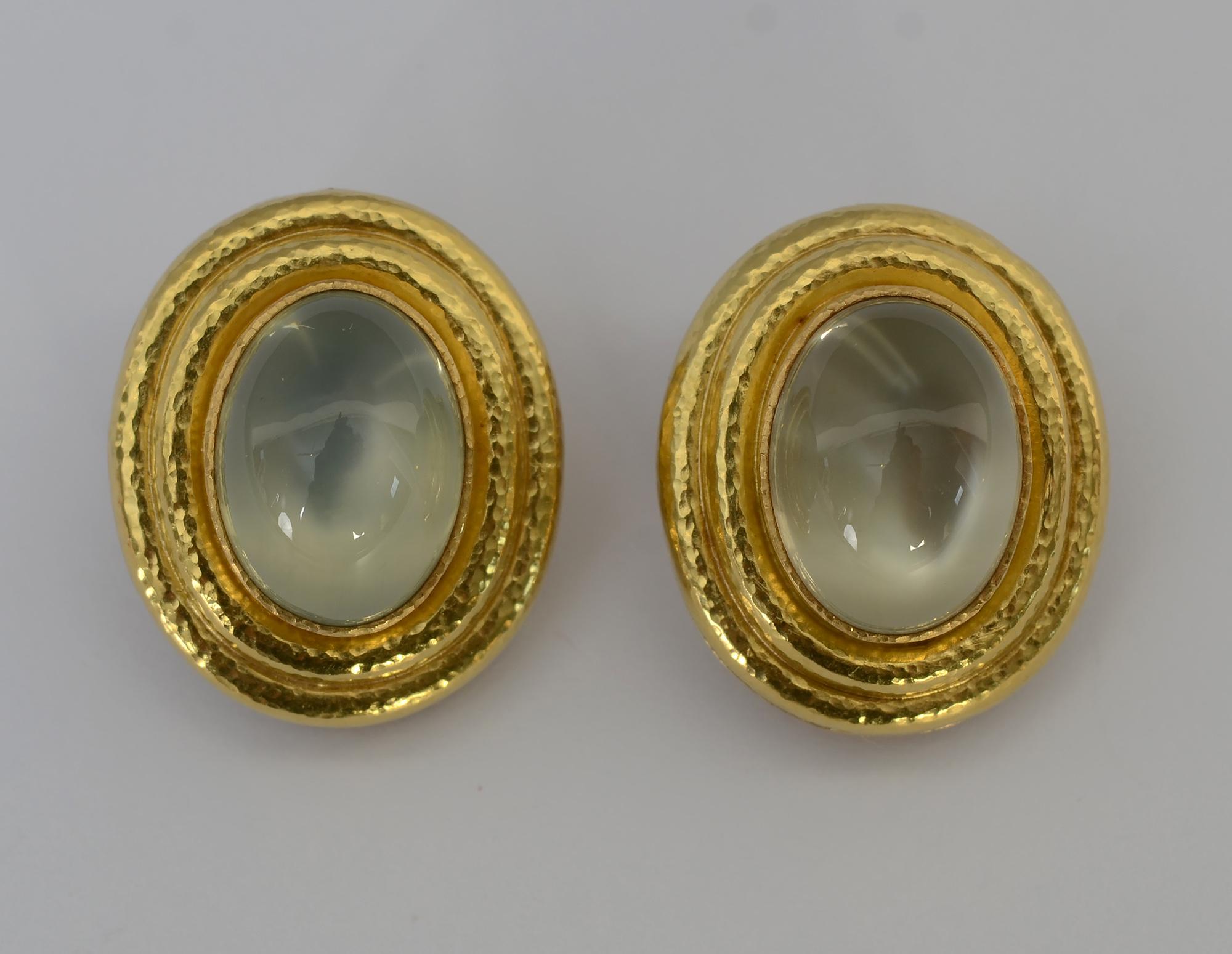 Large oval moonstone earrings by Elizabeth Locke. The stones each measure approximately 15.95 x 12 mm. They have more translucence than may appear in some of the photos. They are bezel set with two stepped tiers of Locke's signature hand hammered