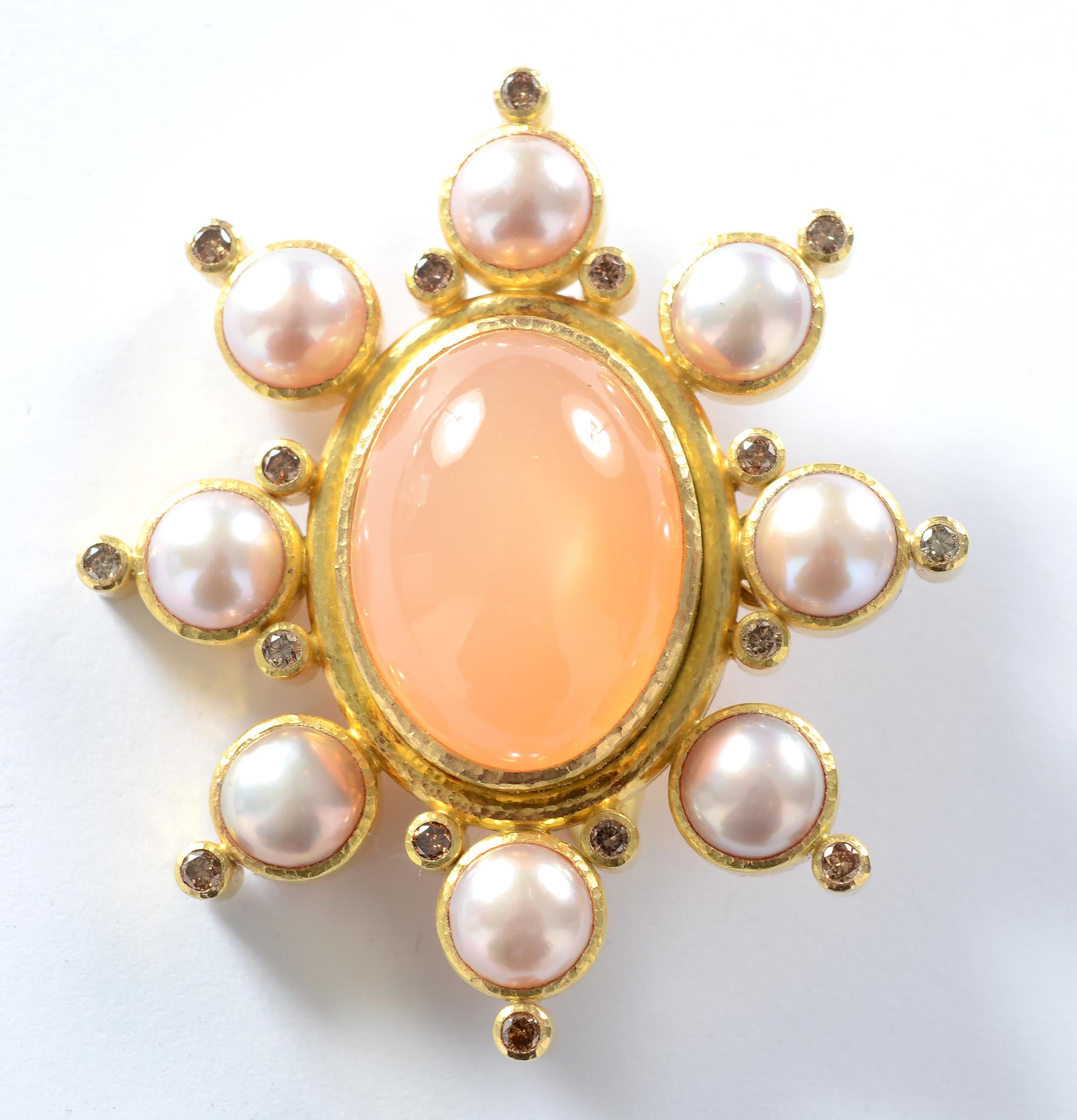 Softly toned brooch/ pendant by Elizabeth Locke with a large central peach colored moonstone. The stone measures 1 1/16