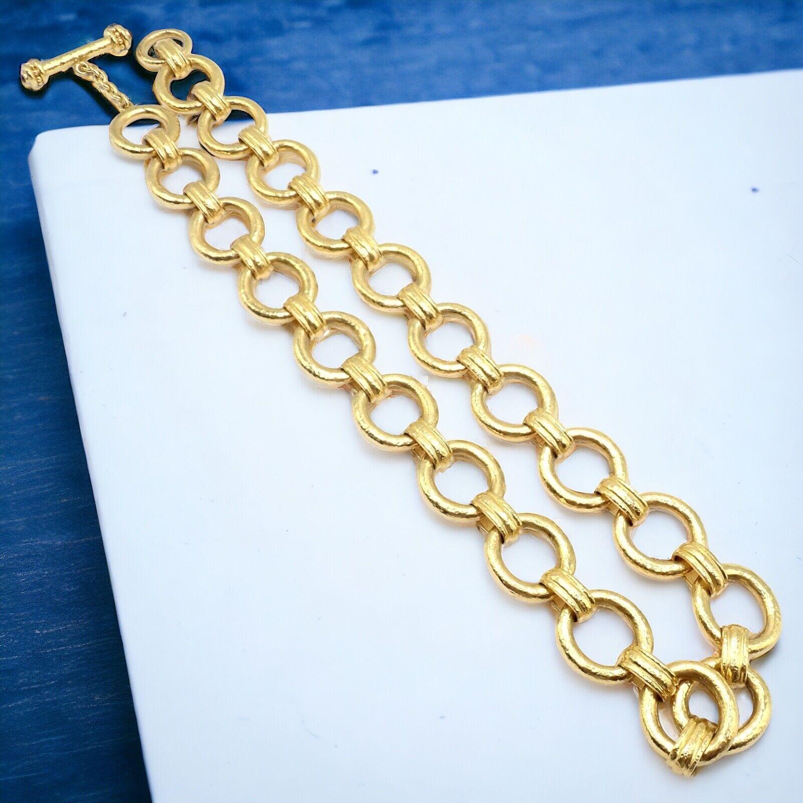 19k Yellow Gold Link Necklace by Elizabeth Locke. 
The Elizabeth Locke 19k yellow gold necklace features a luxurious toggle link design, stretching 21 inches in length. 
Embellished with rich, radiant rubies at the toggle.
This piece epitomizes