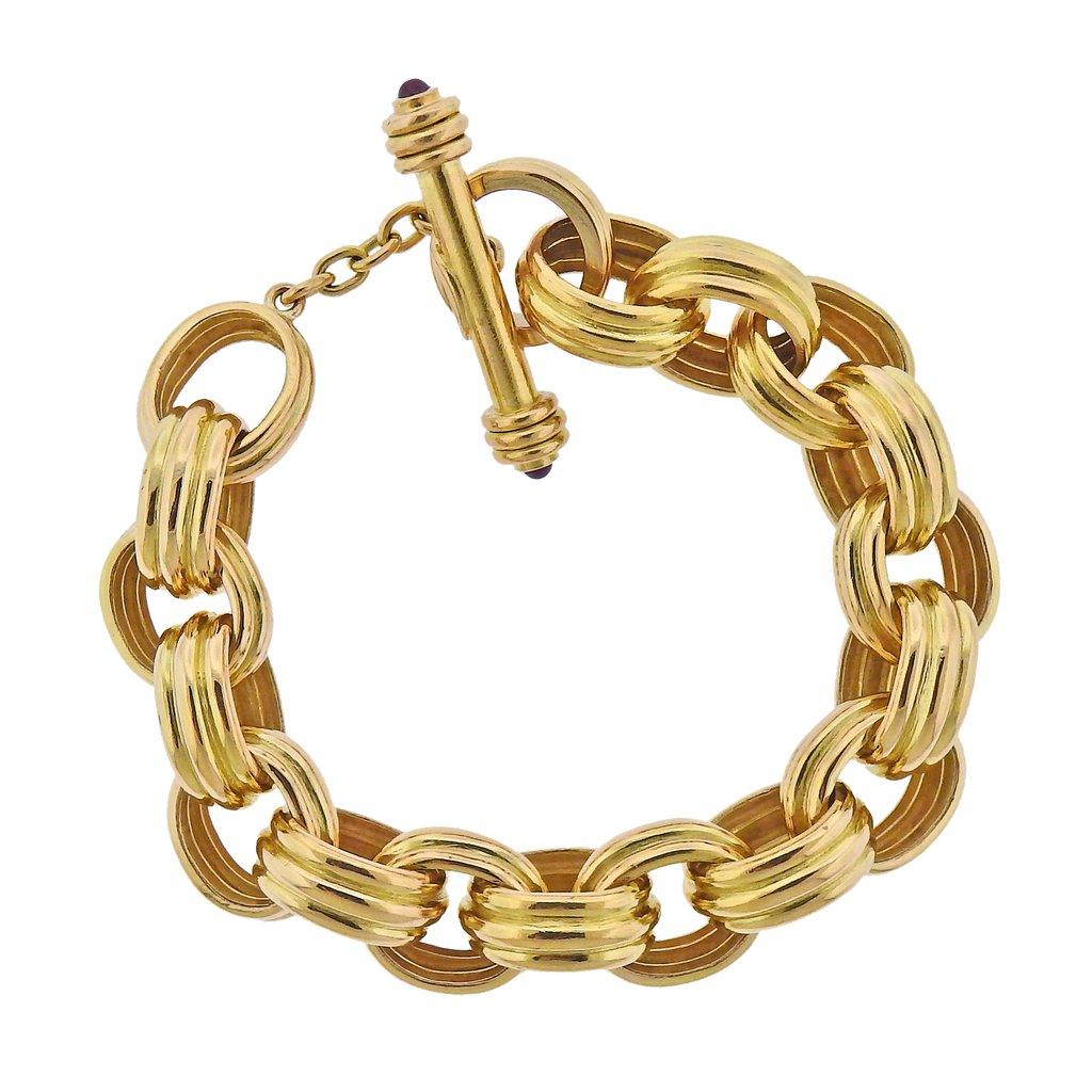18K Gold oval toggle link bracelet by Elizabeth Locke set with ruby cabochons on toggle. Bracelet measures 8