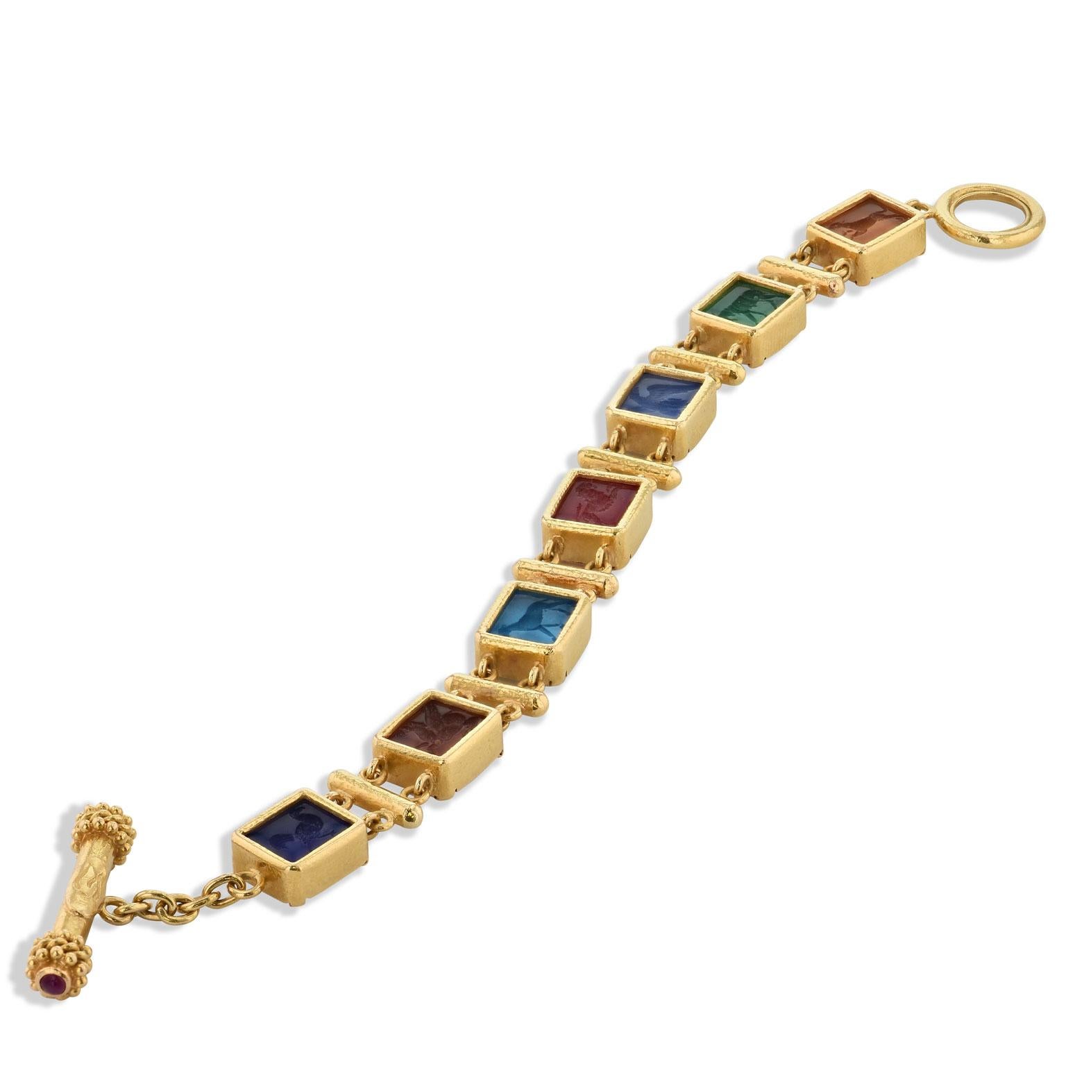 This previously loved Elizabeth Locke 19 karat yellow gold toggle bracelet features seven multi-color intaglio incised antique animals in Venetian glass. Measuring 11 millimeters wide, make a bold statement with this spirited piece (Retail $8,300).