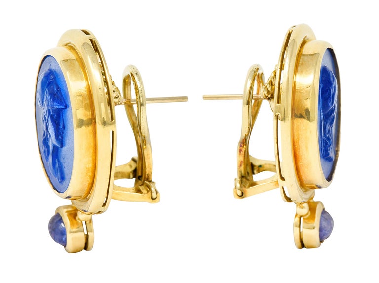 Earrings center 18.0 mm round bezel set Venetian glass cameos of the Greek goddess Athena

Transparent and bright blue in color - backed by iridescent white mother-of-pearl

Accented by deeply ridged and high polished gold surround

With 3.0 x 5.0