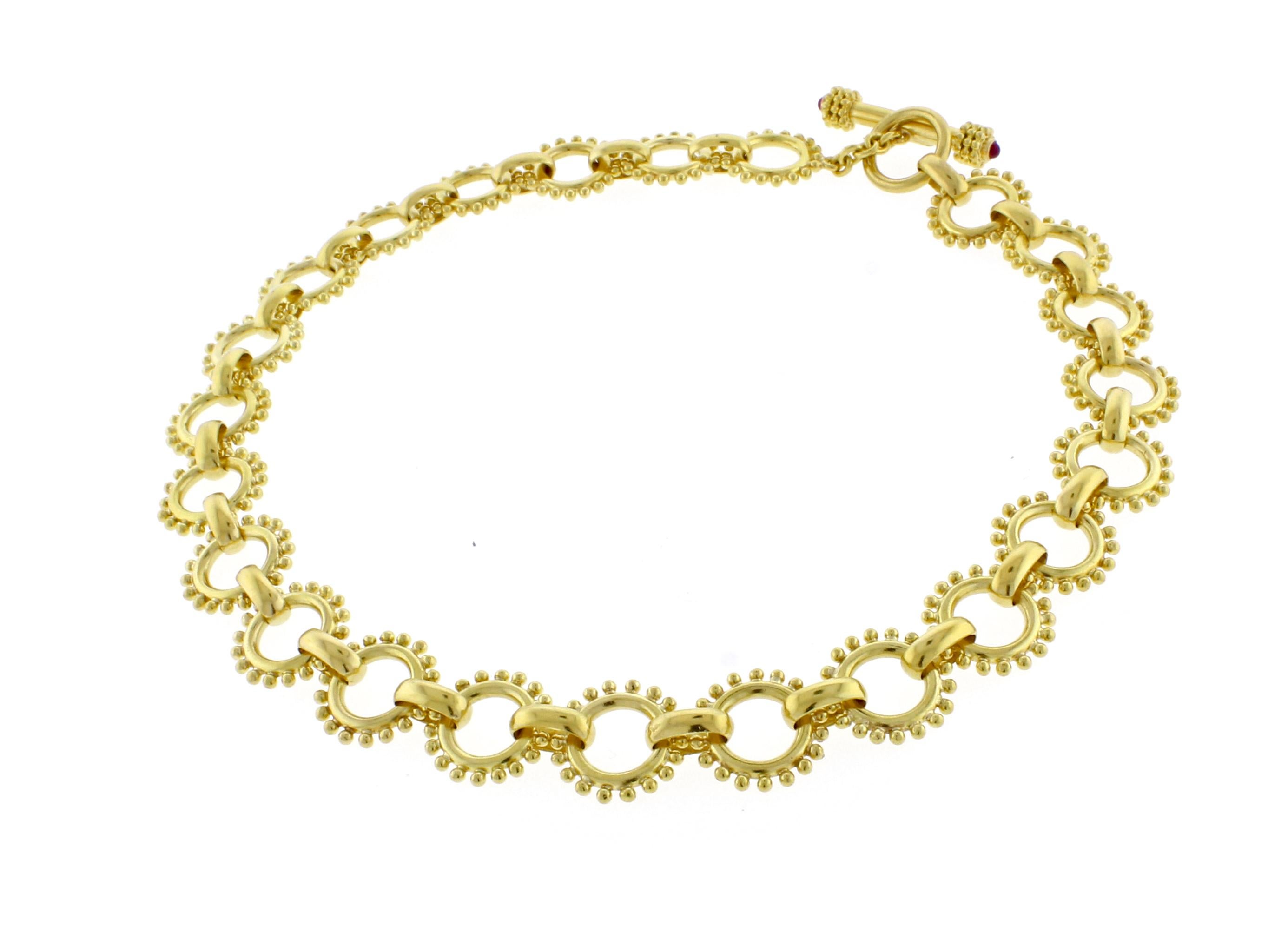 From Elizabeth Locke, a heavy round link toggle 19 karat necklace. The spoked round links measure 18mm, the necklace measures 17 inches. 112.3 grams