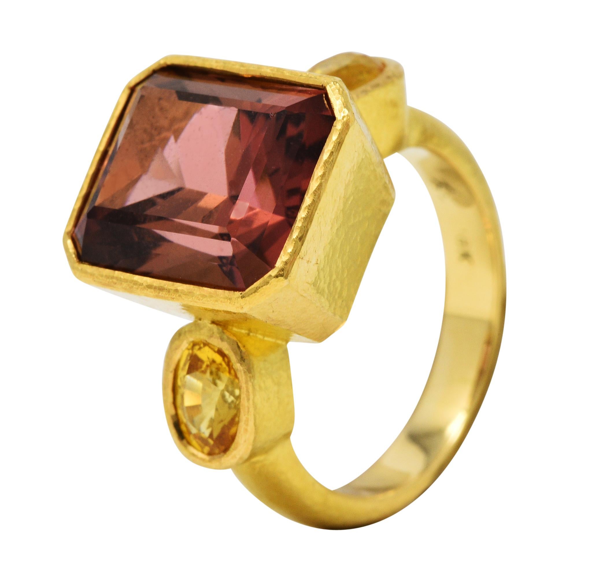 Centering an emerald cut tourmaline weighing approximately 8.25 carats

Remarkable transparent with strong peachy pink color

Flanked by oval cut yellow sapphires, very well matched, while weighing in total approximately 1.40 carats

All are bezel