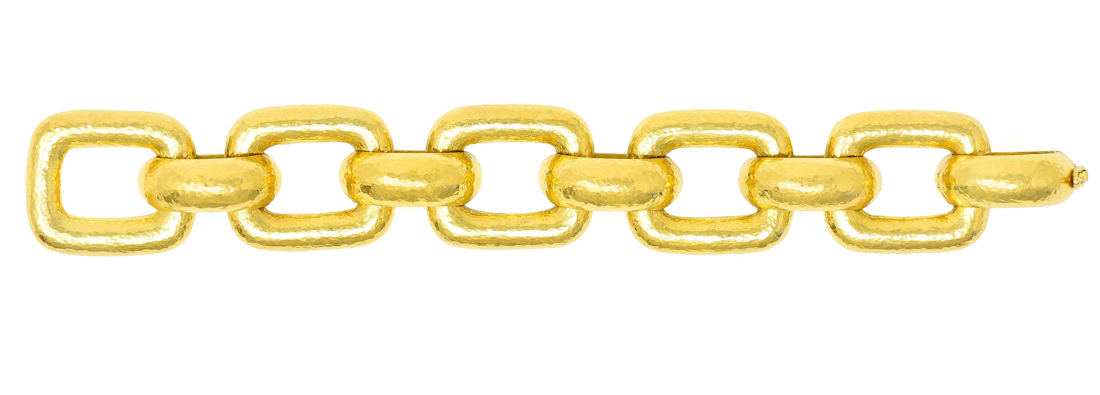 Bracelet is designed as substantial rectangular links alternating with half round links. Rounded with flat backs. With hammered gold texture throughout. Stamped 19k for 19 karat gold. With maker's mark for Elizabeth Locke. Circa: 1980's from the