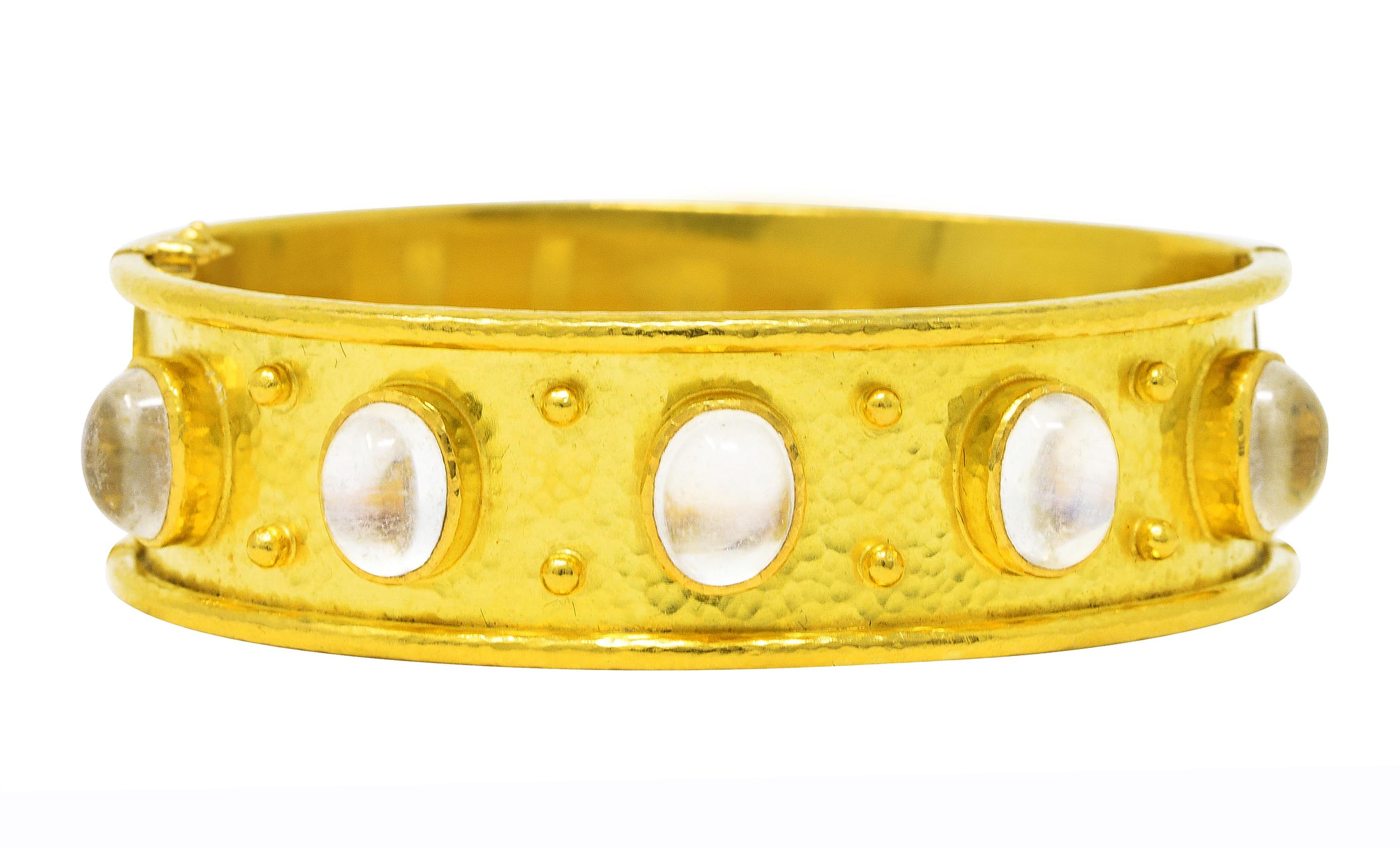 Bangle bracelet features five 6.5 x 8.5 mm oval moonstone cabochons - bezel set to front

Translucent white in body color with subtle blue adularescence

With fluted surround and accented by decorative gold beading

Accented by hammered gold texture