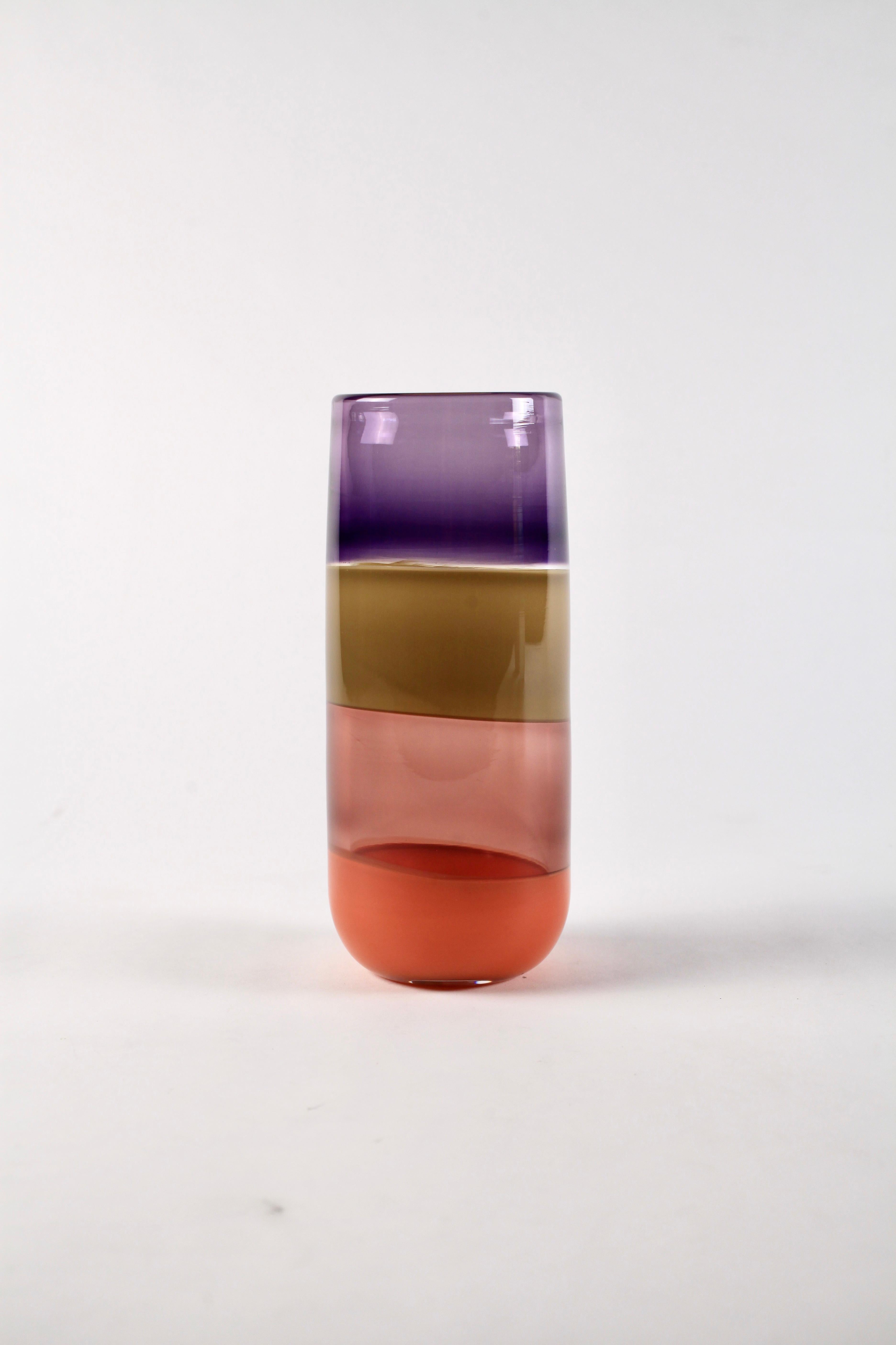 This colorful incalmo striped cylinder vase by Elizabeth Lyons will be sure to add a rich pop of color and a statement to any space. With the interaction of hue, opacity and saturation in mind, four distinct colors have been carefully selected for
