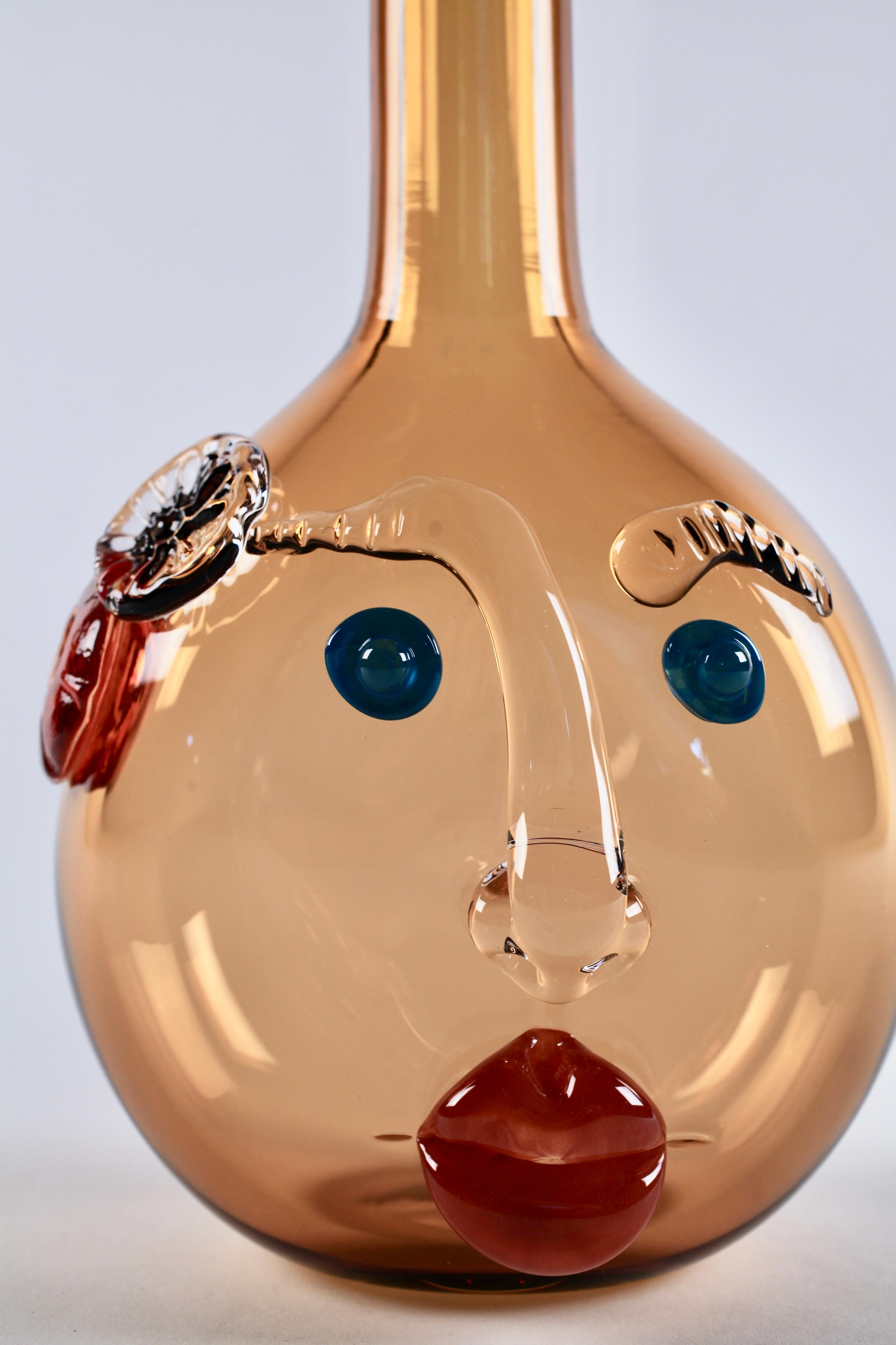 Hand blown and hot sculpted glass, this amber Bottle-head vessel by Elizabeth Lyons is both playful and sophisticated, blooming with a personality all its own. Elizabeth makes these sculptural hand blown bottles in her Rochester, NY studio. Their