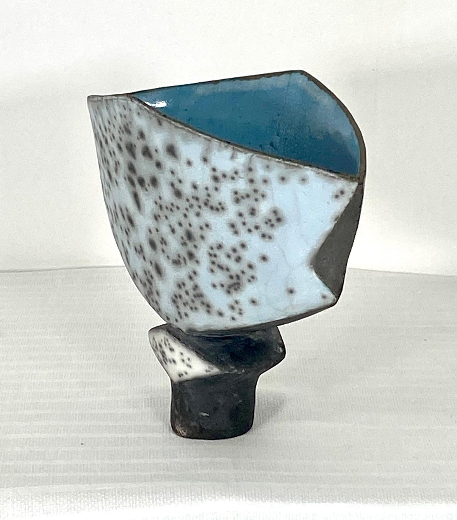 Sculptural vase by Elizabeth Raeburn United Kingdom potter. Blue Ruku glaze abstract Studio art pottery vase. Measures: 9 inches wide by 5 inches deep by 8 inches high.