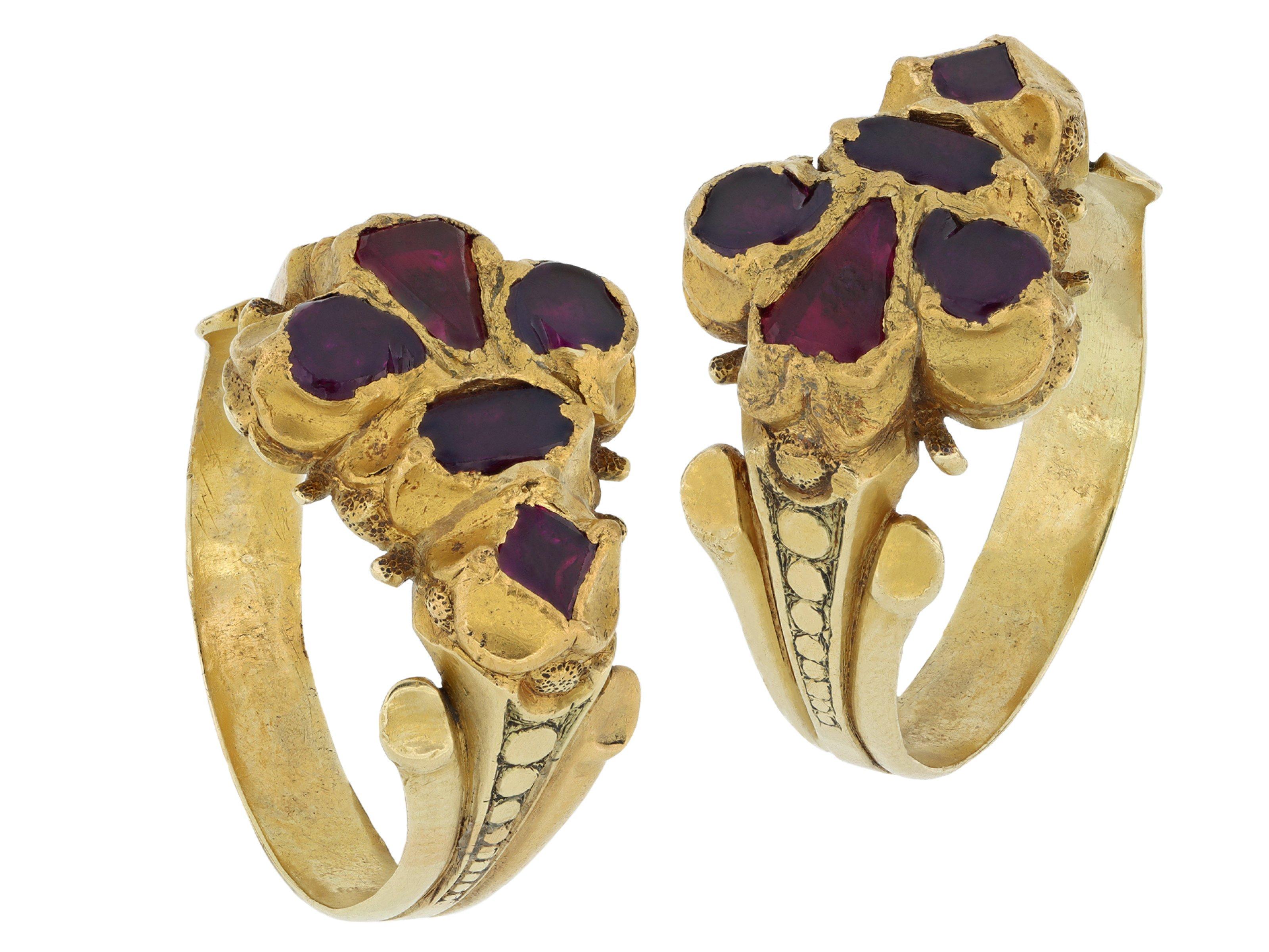 Elizabethan Burmese ruby Fleur-de-lis ring. Set with five table cut natural unenhanced Burmese rubies in closed back quatre-foil settings, to an impressive fleur-de-lis design featuring intricately carved goldwork and closed backholing, leading to