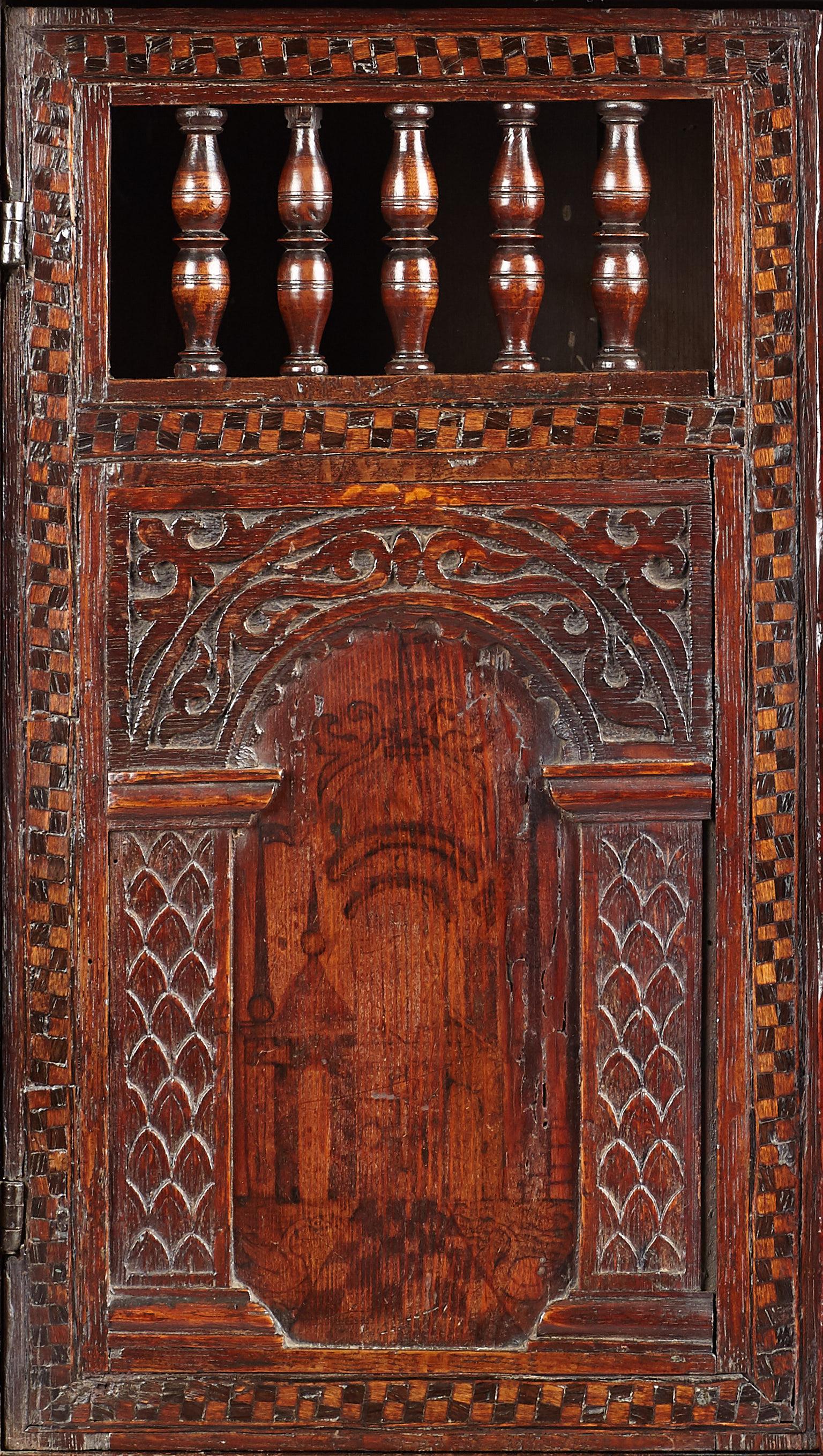 Rare small Late Elizabethan painted pine, oak, parquetry and pen-work decorated mural / glass cupboard,
English, circa 1580-1600.

Featuring black and colored pen-work decoration simulating floral inlays on the upper friezes, divided by lion and