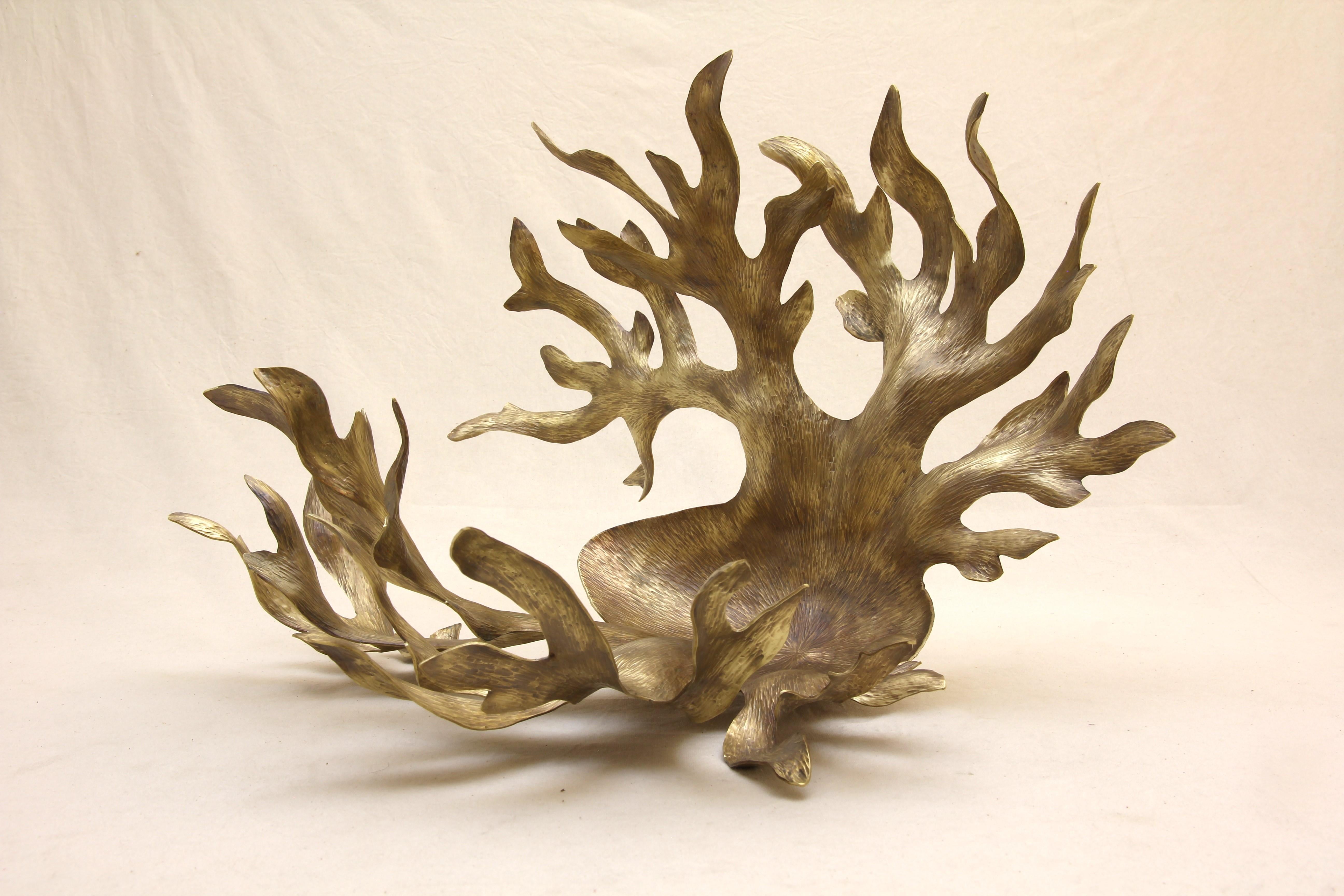 Inspired by the wonderful shapes of the majestic Elk antlers, this organic centerpiece is made out of aged Tumbaga.
100% hand made by expert craftsmen, each sheet of metal is hand hammered, cut and twisted using metal and wood as a last to give each