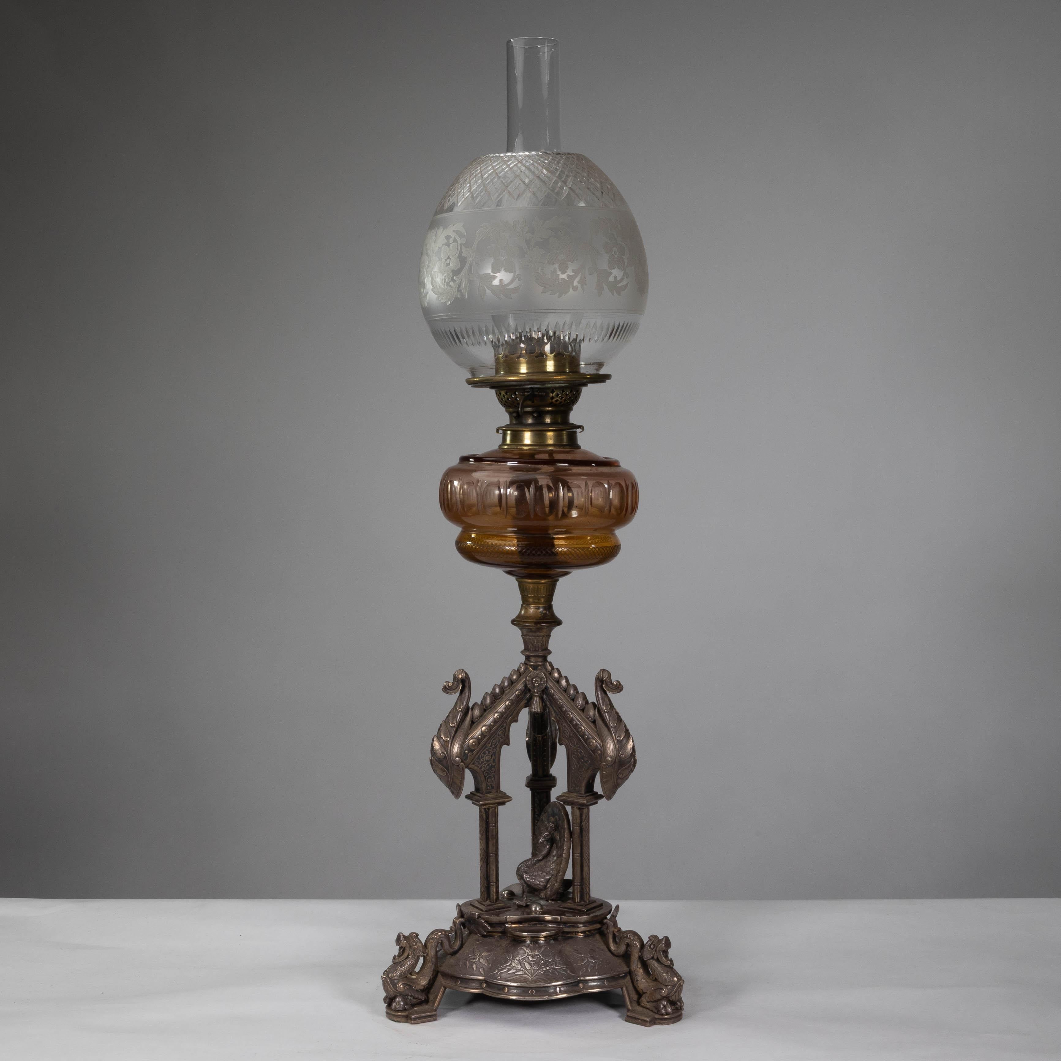 An impressive exhibition quality Aesthetic Movement silver plated oil lamp by Elkington. Decorated with a central peacock beneath three Nordic style architectural cross beams supported on three tri-form gilt column uprights emulating bamboo