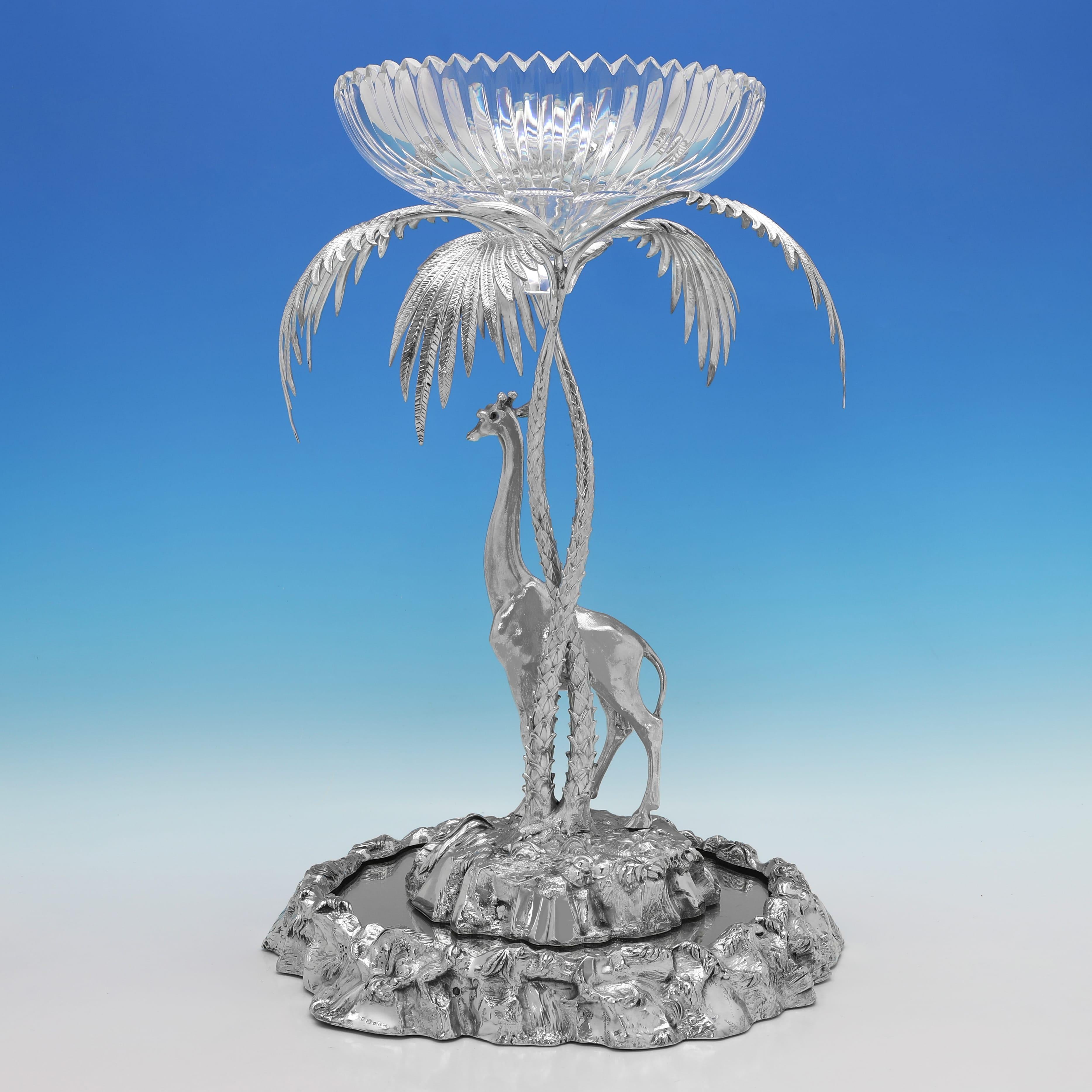 Carrying plate marks for 1884 by Elkington & Co., this charming, Antique, Victorian Silver Plate Centrepiece, is in the naturalistic form, modelled as a giraffe standing under a palm tree which supports a glass bowl. The centrepiece measures