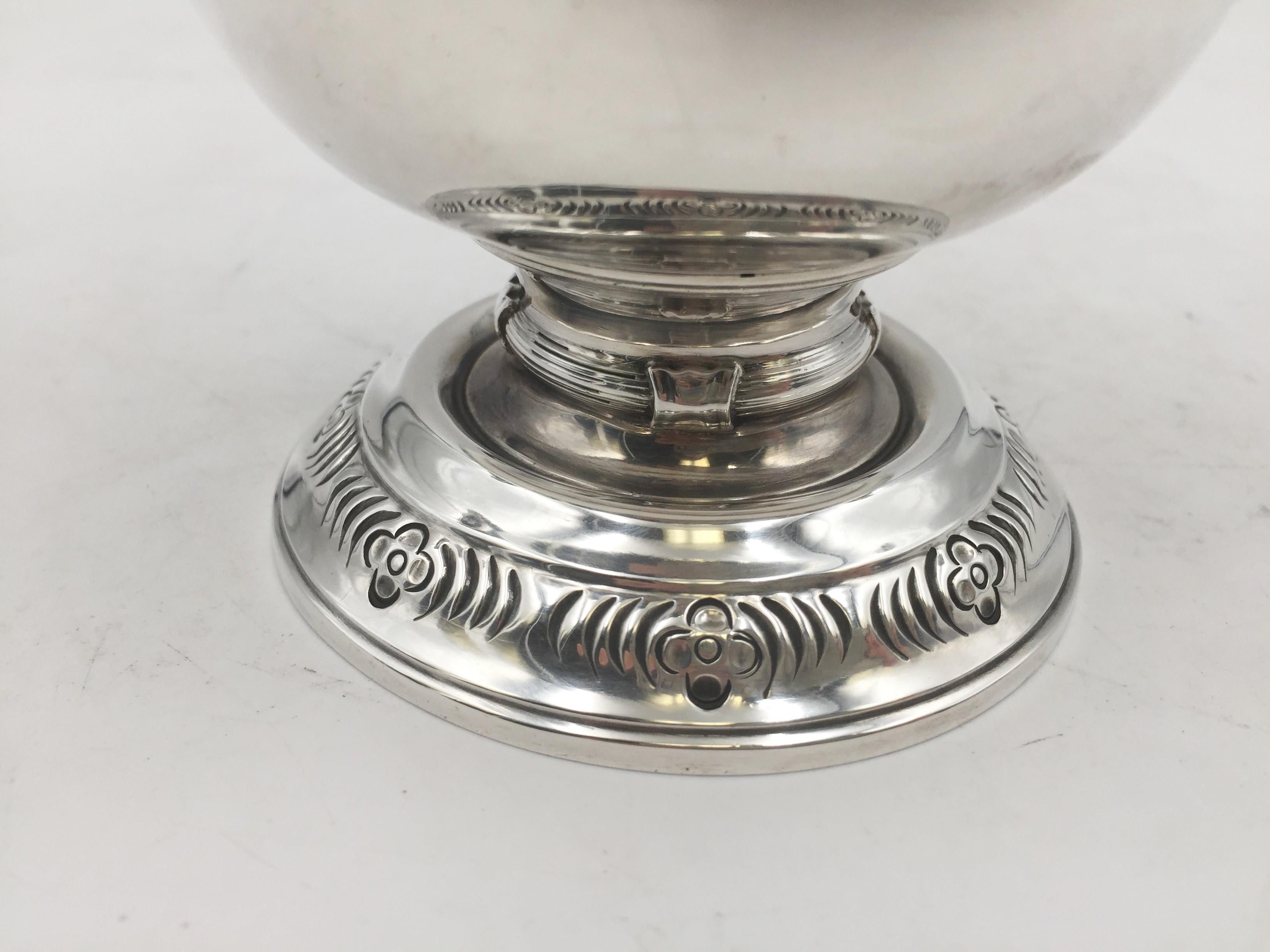 Elkington & Co. sterling silver trophy / centerpiece made in Birmingham, England in 1923 with engraved motifs on the base, ornate handles, applied band on the body, and a finial with animals and stylized natural motifs. It measures 8'' by 7 3/4''