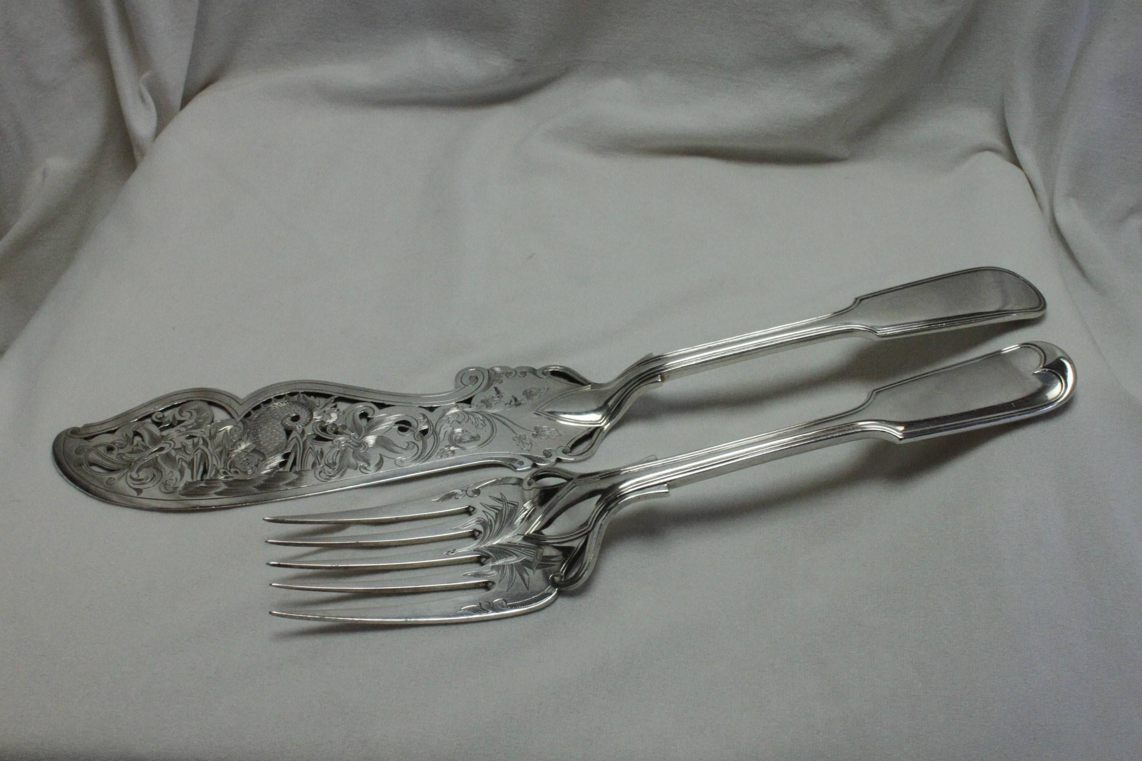 This pair of silver plated pierced and engraved fish servers were made by Elkington & Co. They are of good quality and quite weighty. They are decorated with very ornate and very detailed engraving, more so on the fish slice which features a dolphin