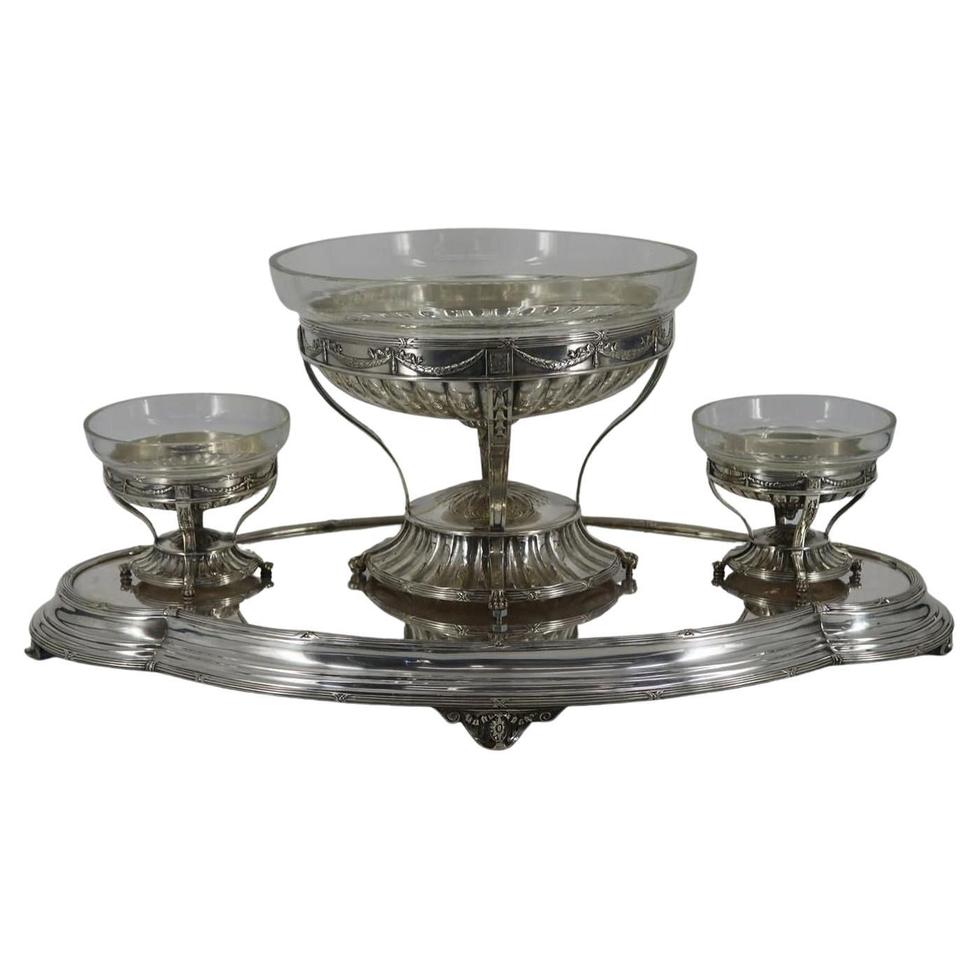 Our large silverplate tray from Elkington and Co. features three footed pedestal bowls with glass liners. Bowls have pegs to the undersides of each foot that fit into the base. Underside stamped with the Elkington marks including W year code for