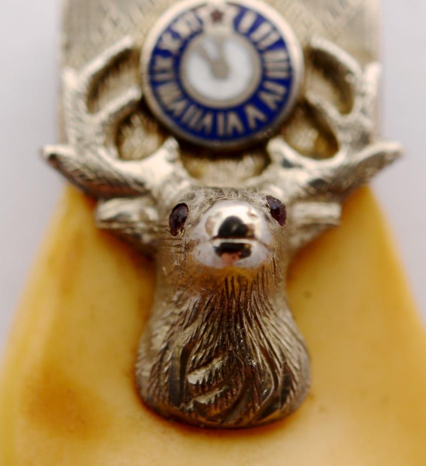 Elks Lodge BPOE Order of Elks Tooth Fob, 10K White Gold, Rubies and Enameling. The Gold mount with cast elks head and antlers. The elk has red cabochon ruby eyes. The Elks is an American fraternal order founded in 1868 originally as a social club in