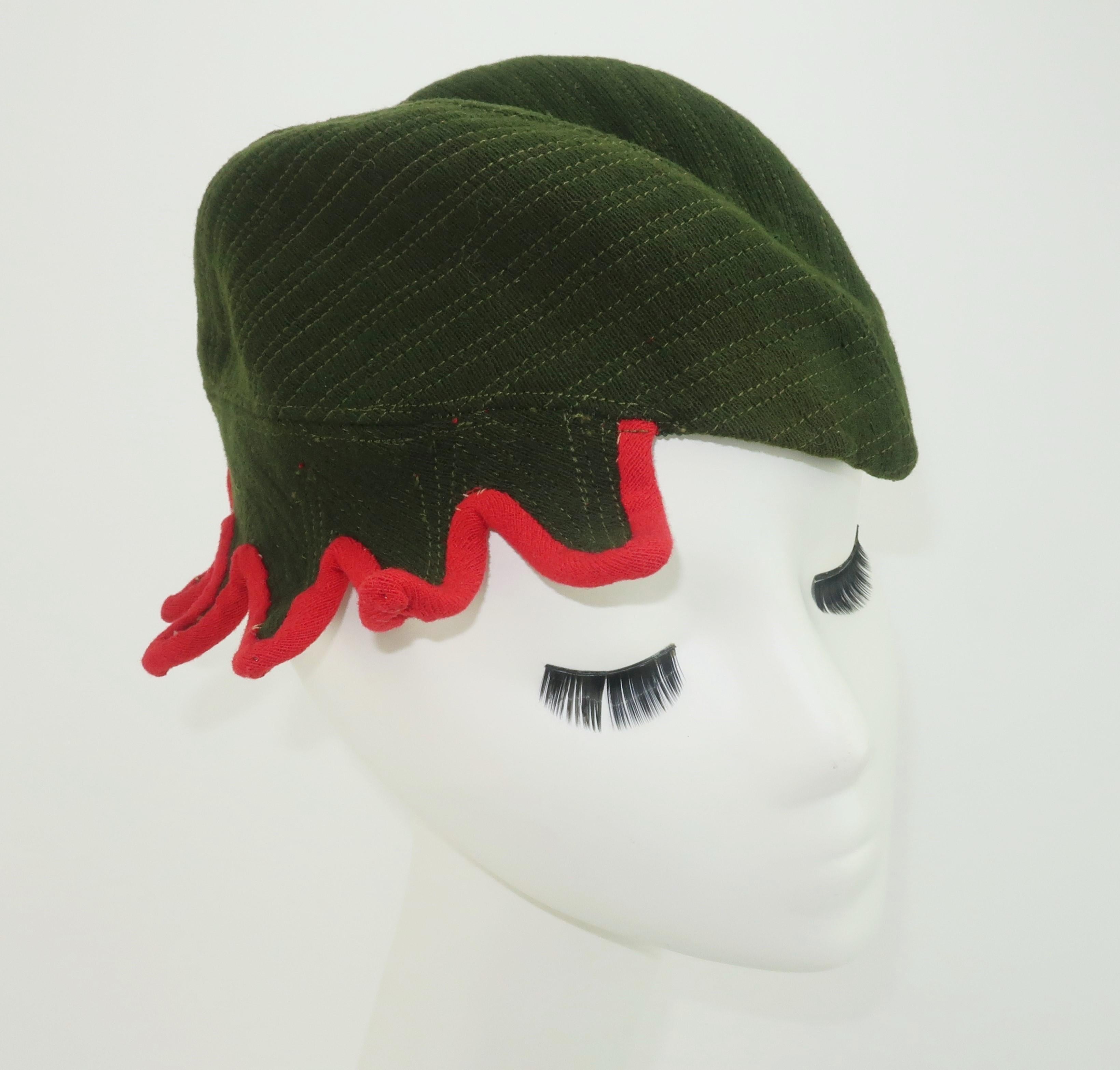 A 1940's army green wool cap with quilted stitching and a whimsical red trim by Atlanta milliner, Ella Buchanan Gunn.  Ms. Gunn started her business in 1899 and was known throughout the South for her unique and stylish designs.  This unusual topper