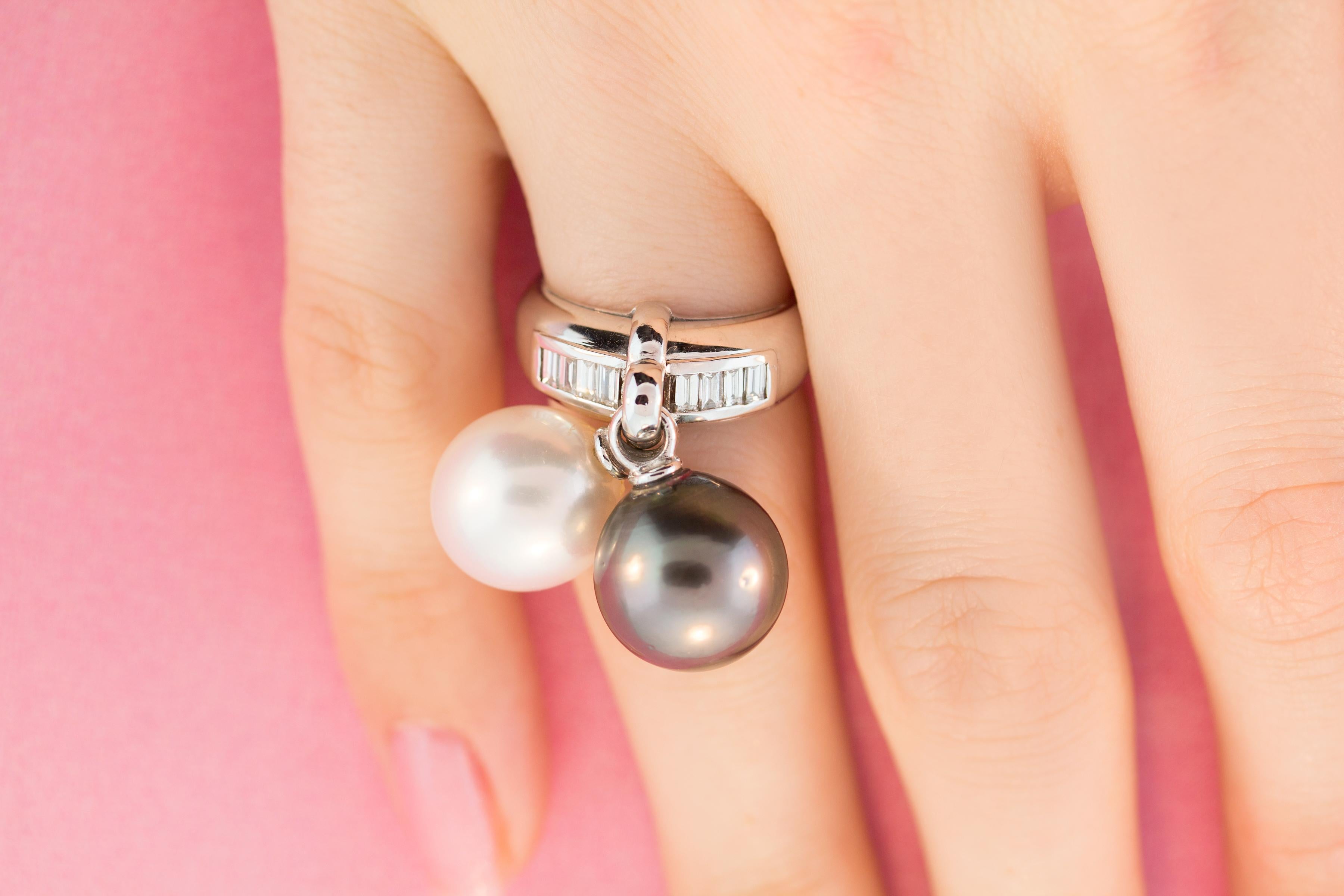 This pearl and diamond ring features two pearls of 12mm diameter each. The pearls are untreated. They display a fine nacre and their natural color and luster have not been enhanced in any way. Each pearl is separately attached to the center of the