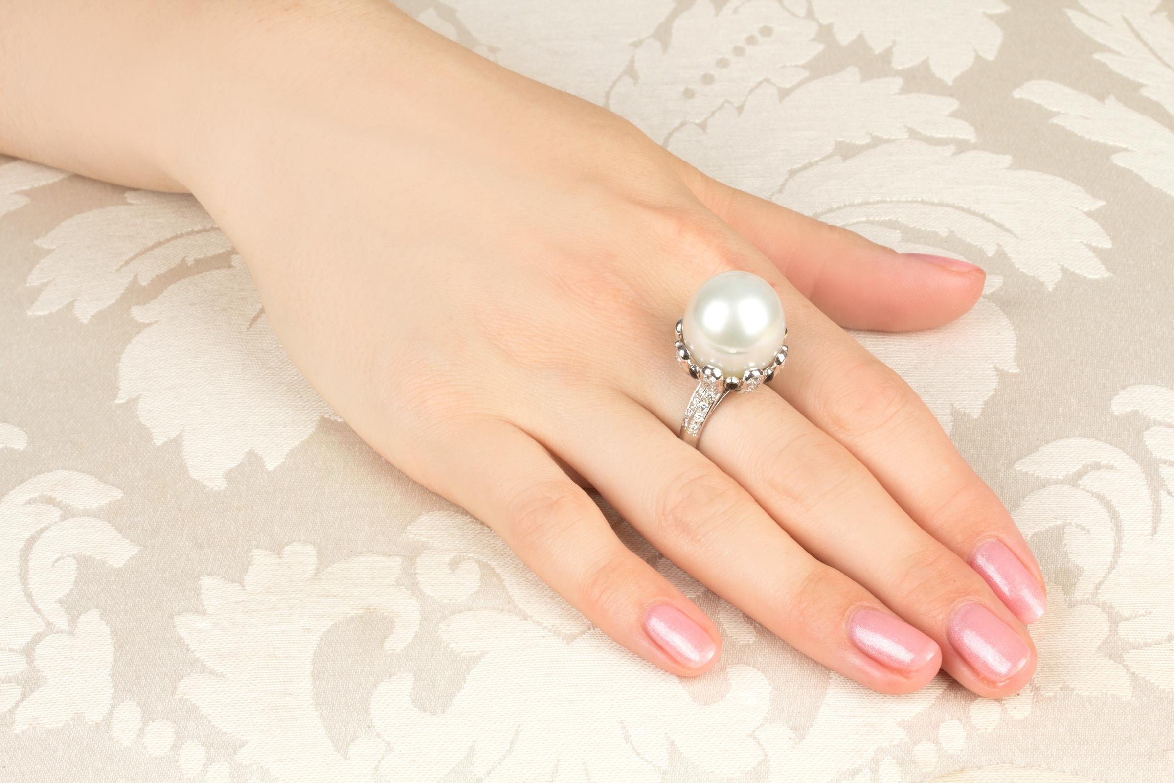 This South Sea pearl and diamond cocktail ring features a large and lovely Australian pearl of 17mm diameter. The pearl is untreated. It displays fine quality nacre and its natural color and luster have not been enhanced in any way. The pearl is set