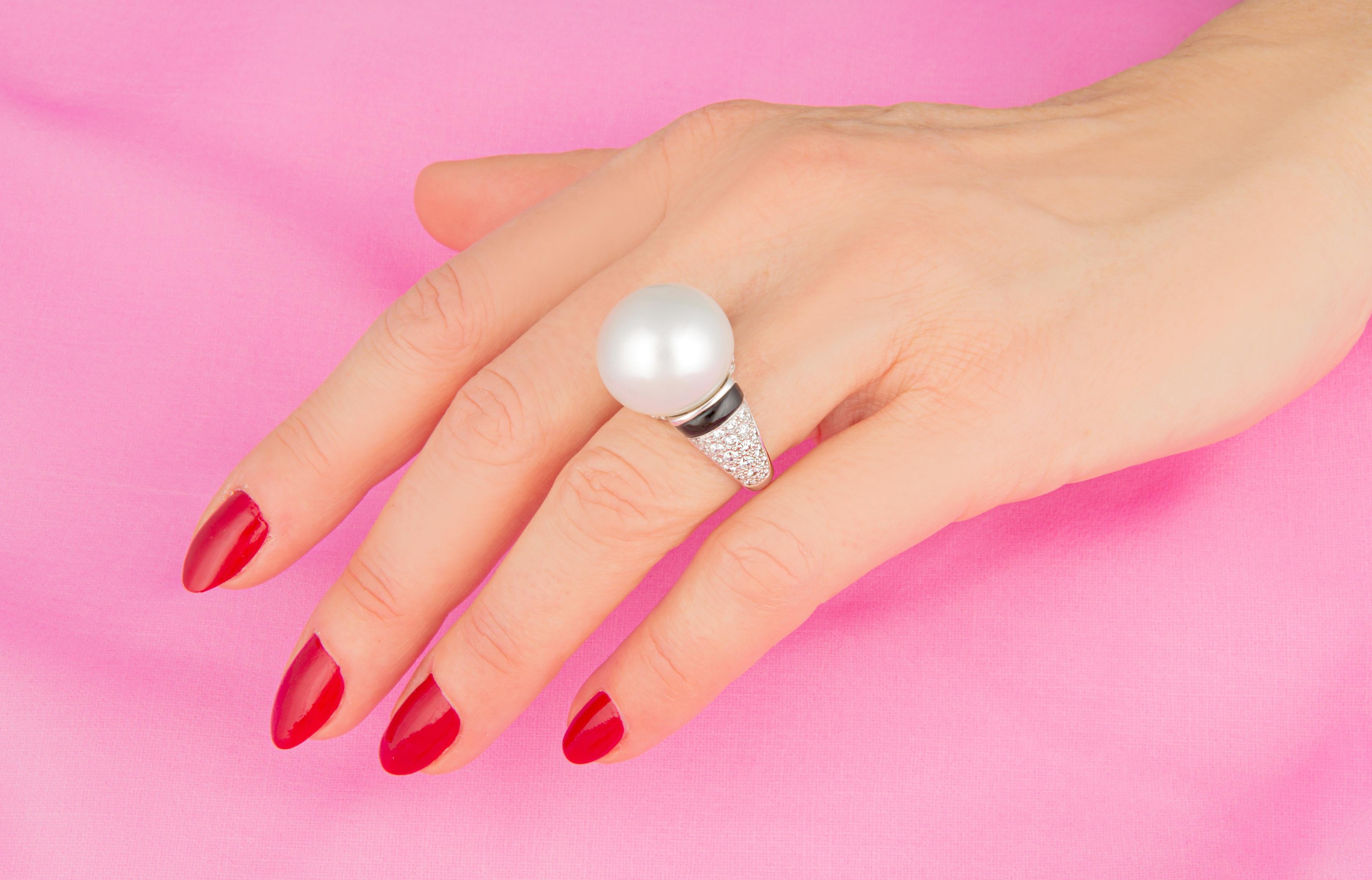 This pearl and diamond cocktail ring features a voluminous South Sea pearl of 18.5mm diameter. The pearl is untreated. It displays a fine nacre and its natural color and luster have not been enhanced in any way. The pearl is highly exposed in an