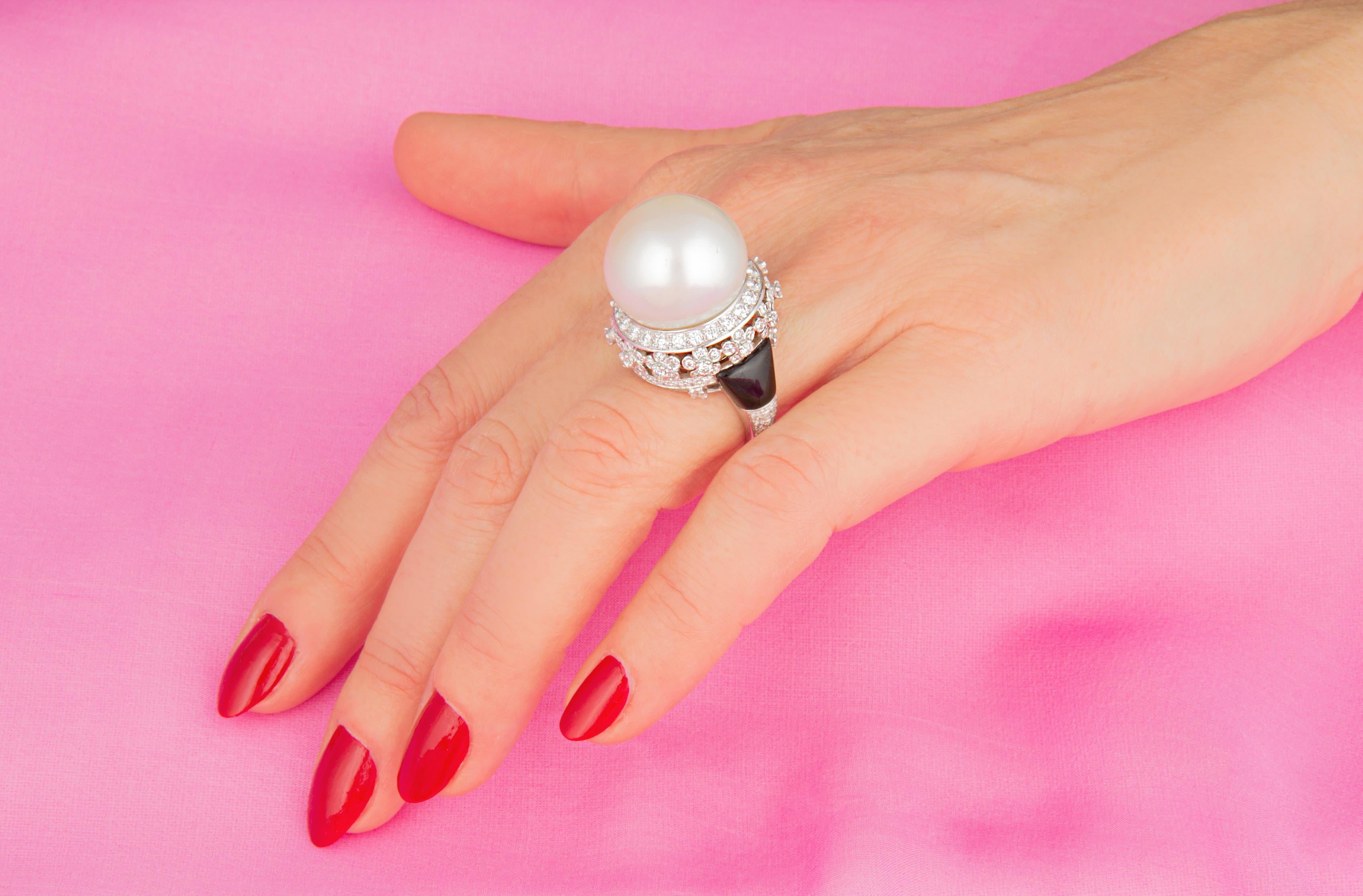 This pearl and diamond ring features an exceptionally large and beautiful South Sea pearl of 19mm diameter. The pearl is untreated. It displays a fine nacre and its natural color and luster have not been enhanced in any way. The pearl is perched on