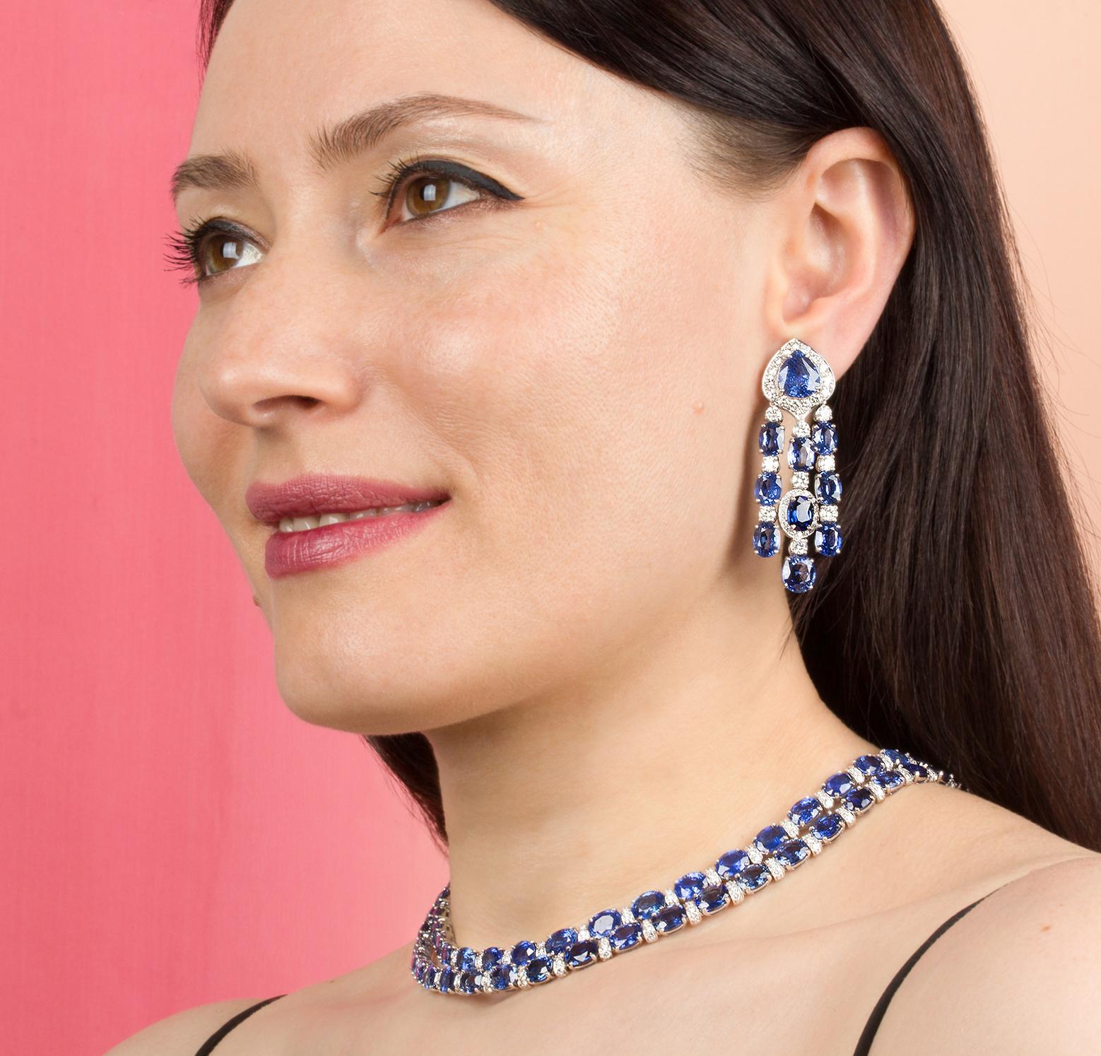 This exceptional blue sapphire and diamond necklace and earrings set features a total of 174.55 carats of oval cut and drop shape faceted Ceylon sapphires of homogeneous and splendid color and quality. The design is complete with 10.90 carats of