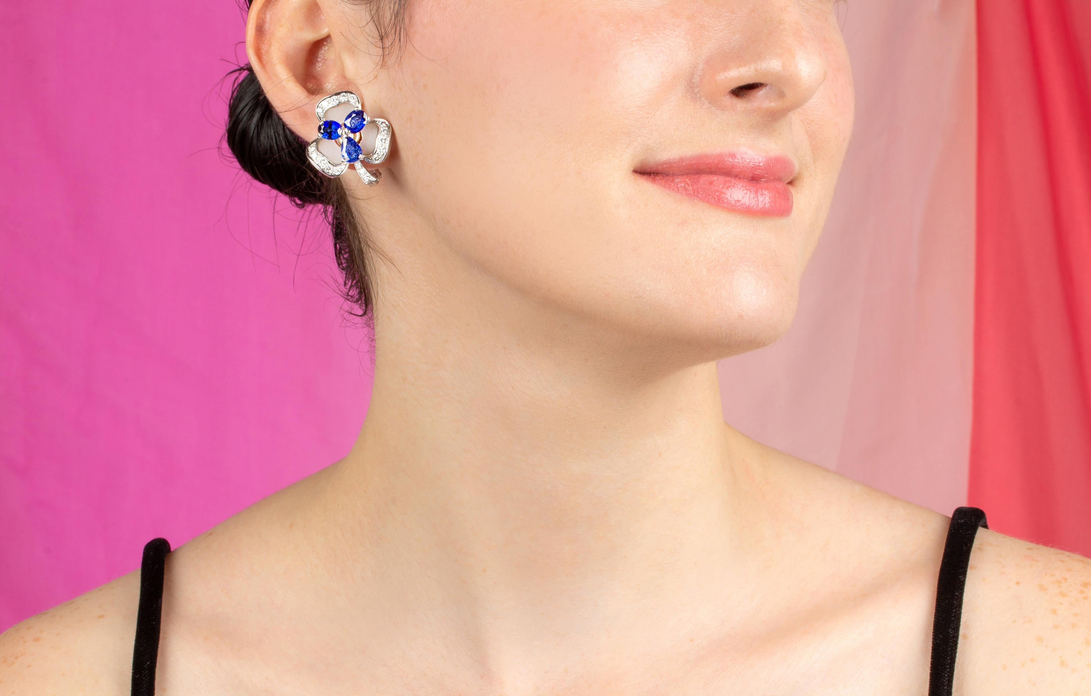The blue sapphire and diamond earrings feature a flower design with oval cut faceted Ceylon sapphires for a total weight of 7.93 carats. The sapphires are set en tremblant, a technique rarely practiced today. The design is complete with a custom cut