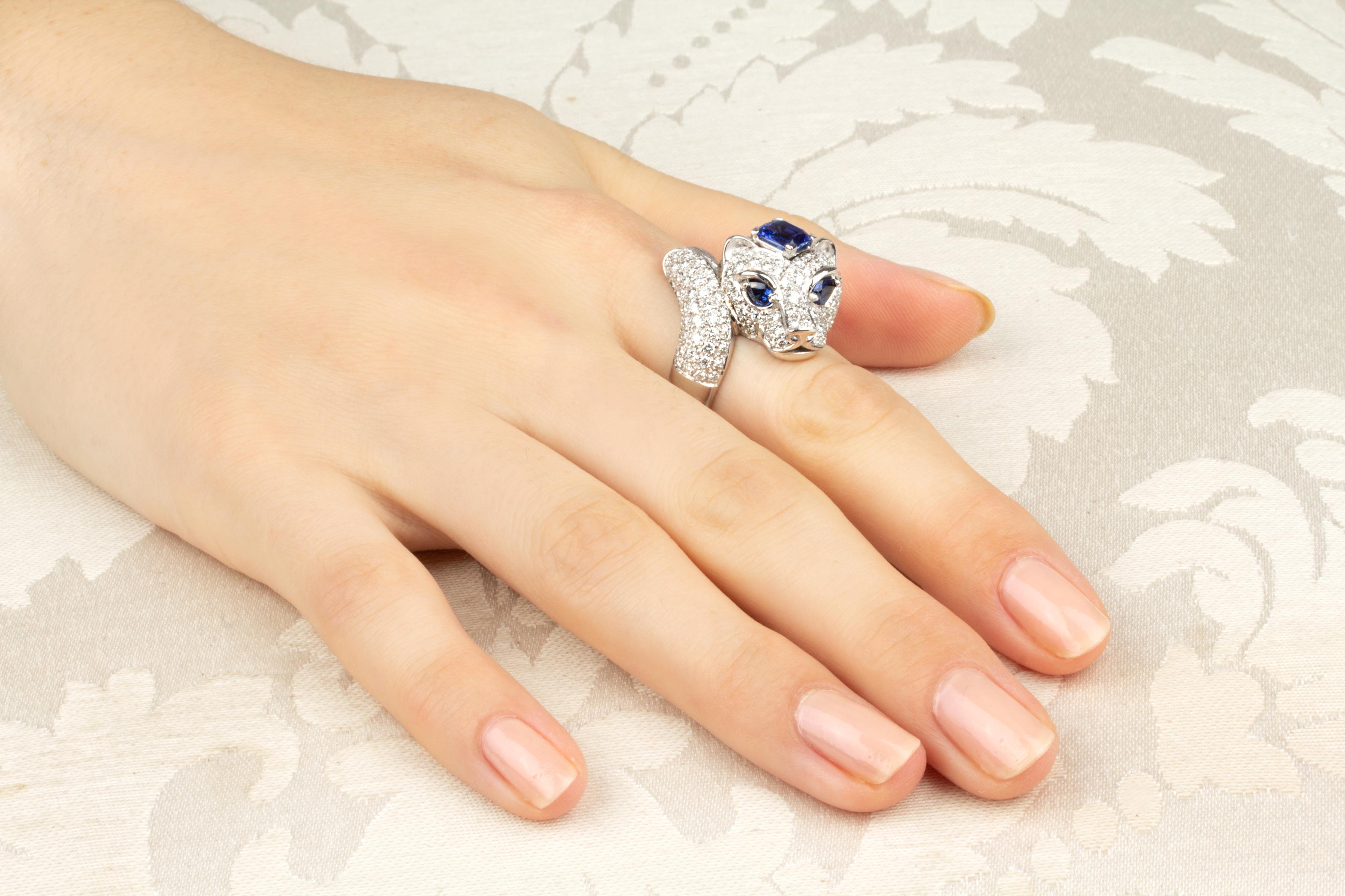 This tiger ring carries 1.70 carats of blue Ceylon sapphire of brilliant quality (tiger crown and 2 eyes). The design is complete with 1.32 carats of round diamonds of top quality set en pavé (F/VVS) in artful fashion. 
The ring is one-of-a-kind. It