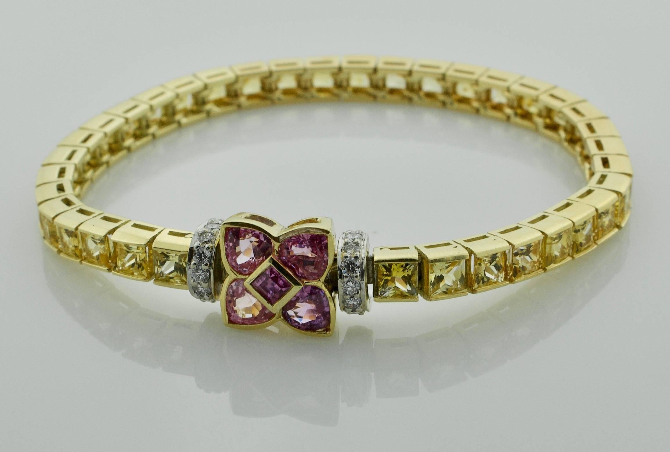 Ella Gafter Golden and Pink Sapphire and Diamonds Gold Flower Tennis Bracelet
Thirty Six French Cut Golden Sapphires weighing 18.00 carats approximately
Five Fancy Cut Pink Sapphires weighing 2.00 carats approximately
Fourteen Round Brilliant Cut