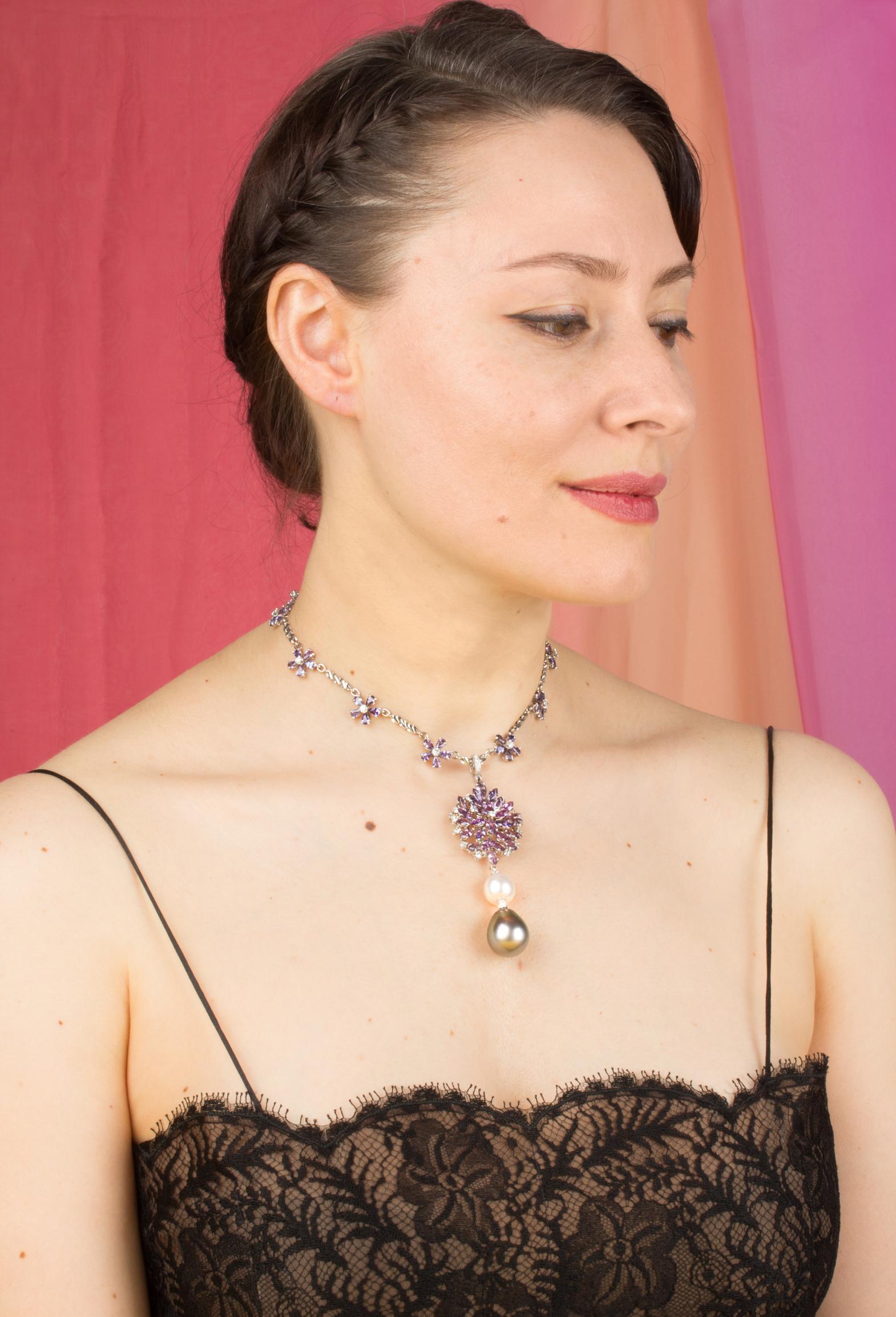 The lavender sapphire and diamond necklace features a spray of marquise shape faceted sapphires spangled with a crown of round diamonds. The jewel suspends an intermediary South Sea pearl and a Tahitian pearl of the rare size of 19 x 16mm. The 3.25”