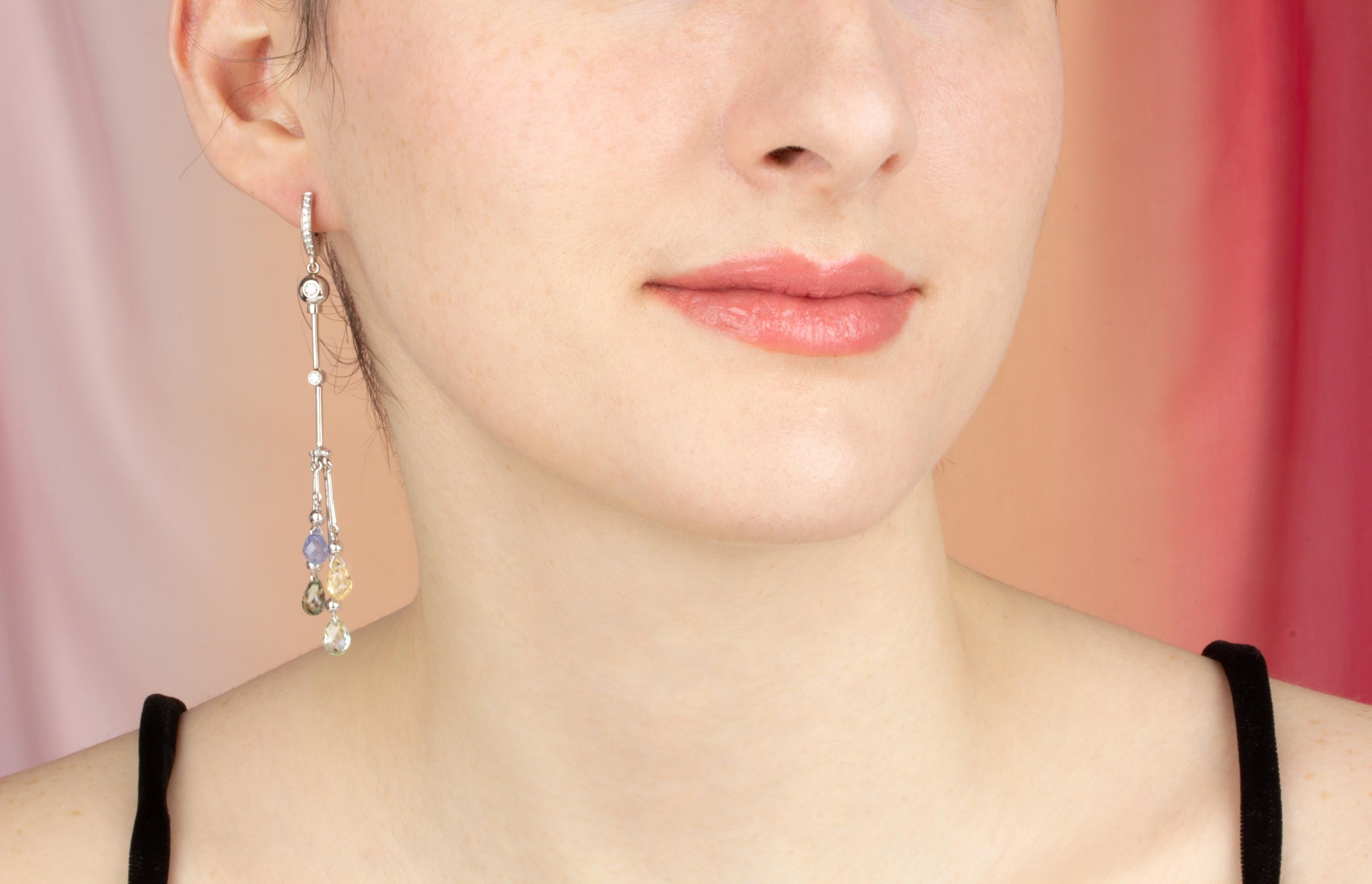 These multicolor sapphire and diamond drop earrings feature 8 briolette sapphires of different colors for a total of approximately 10 carats in a playful and flexible design. The earring is complete with 0.45 carats of round diamonds of top quality