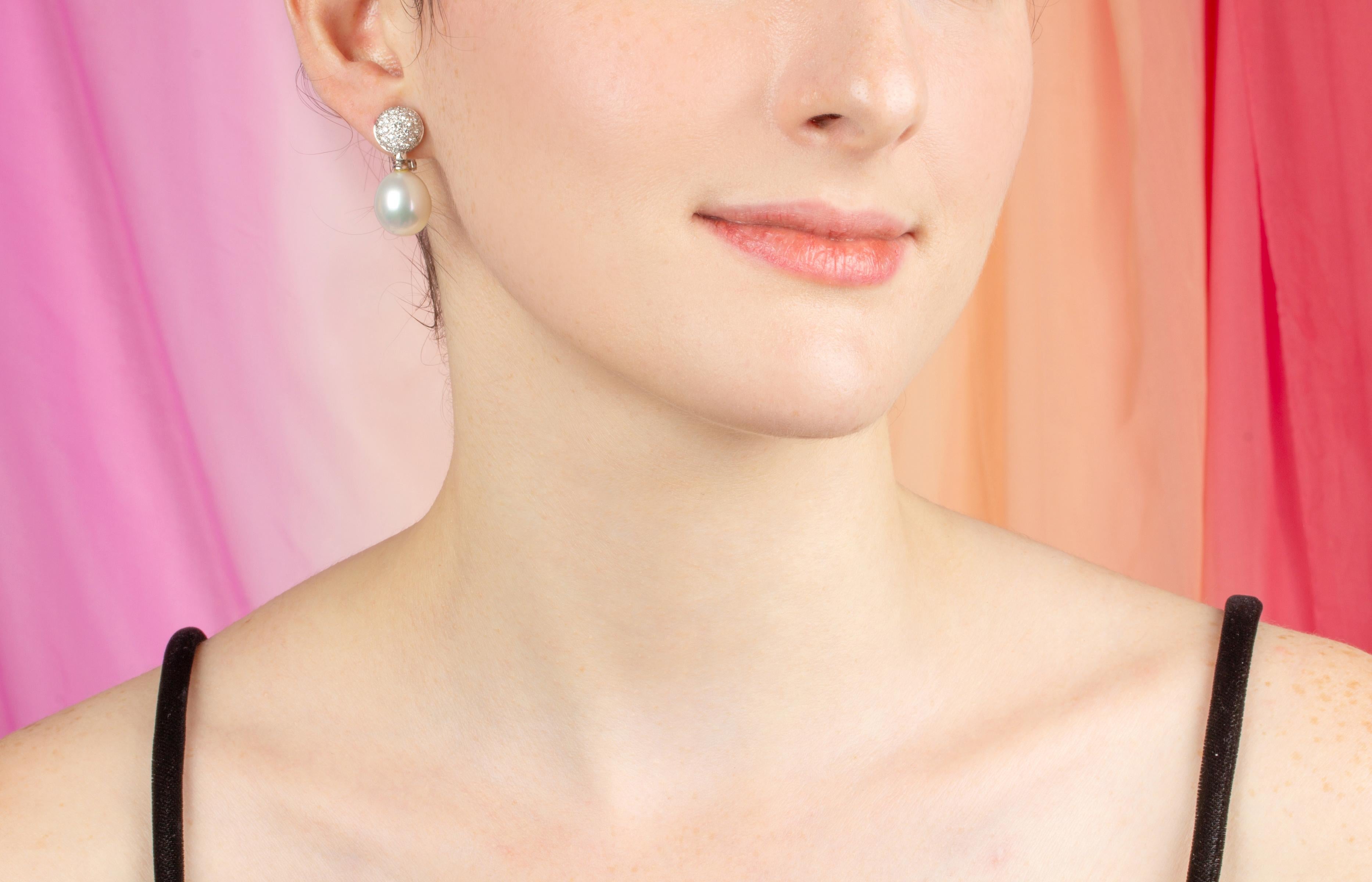 The South Sea pearl and diamond earrings feature two untreated oval shape pearls (14 x 15mm) from the waters of Northwestern Australia. They display fine quality nacre and their natural color and luster have not been enhanced in any way.
The pearls