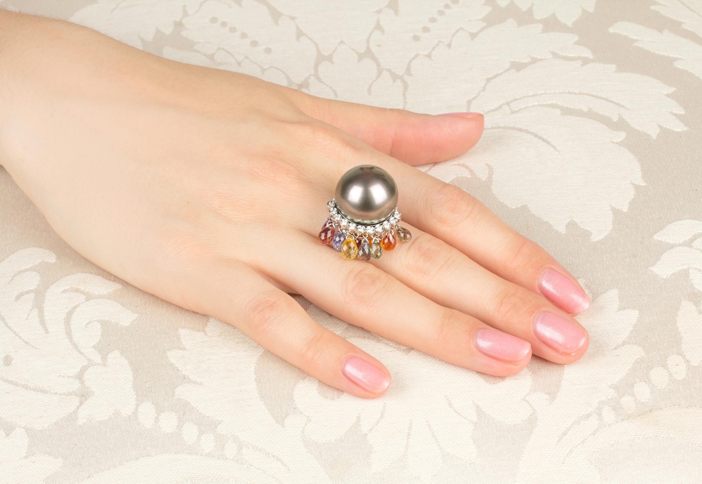 This Tahitian pearl and diamond ring features a particularly large and attractive pearl of 17.5/18mm diameter. The pearl is untreated. It displays a fine nacre and its natural color and luster have not been enhanced in any way. The pearl is perched