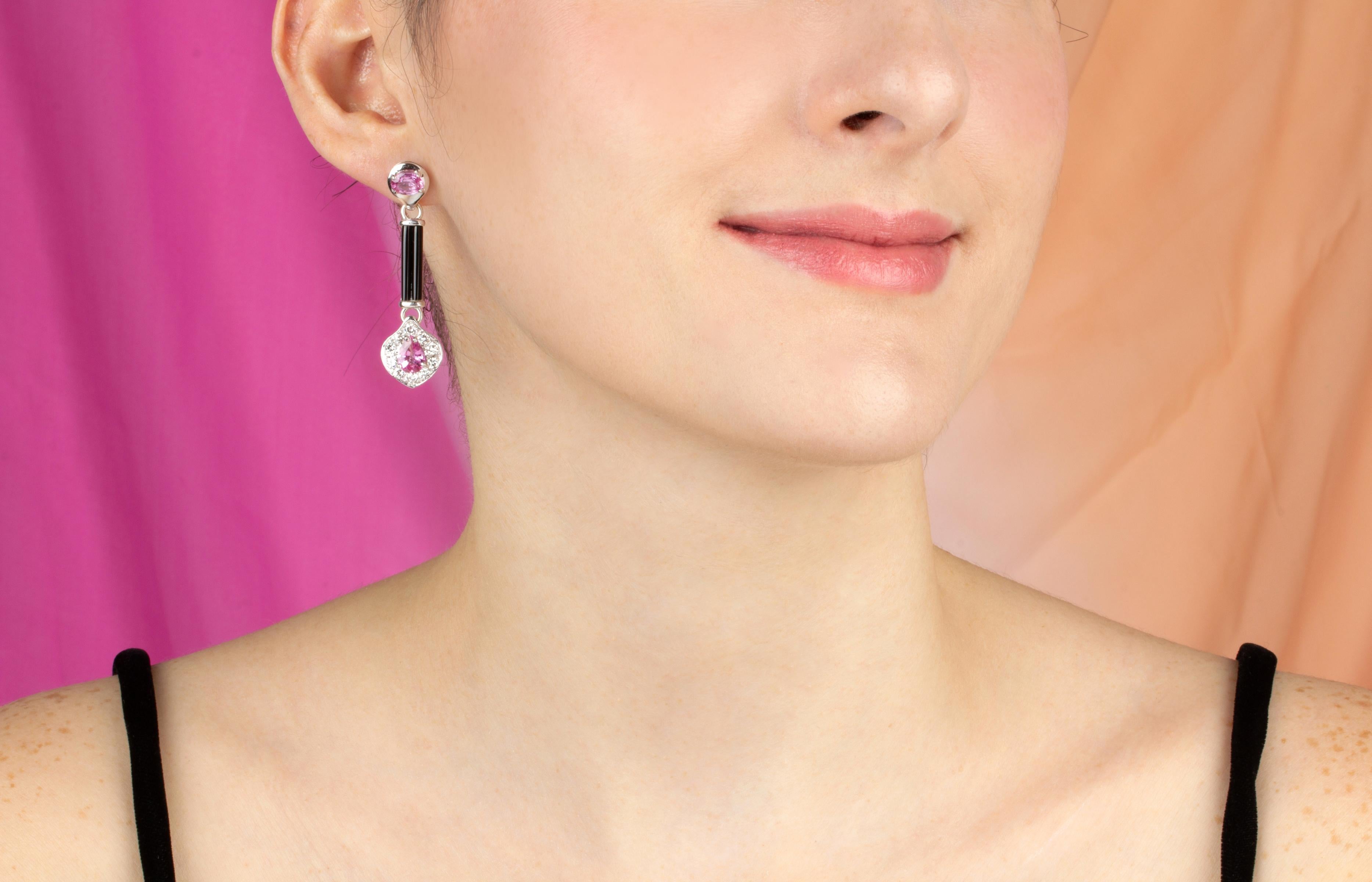 These pink sapphire and diamond drop earrings feature 4 faceted sapphires for a total of 3.40 carats in a playful design with black onyx, lending the jewel a distinctive art déco look, and 1.58 carats of round diamonds of top quality (color, clarity