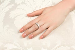The princess cut diamond ring features a row of 6 calibrated  diamonds for a tot